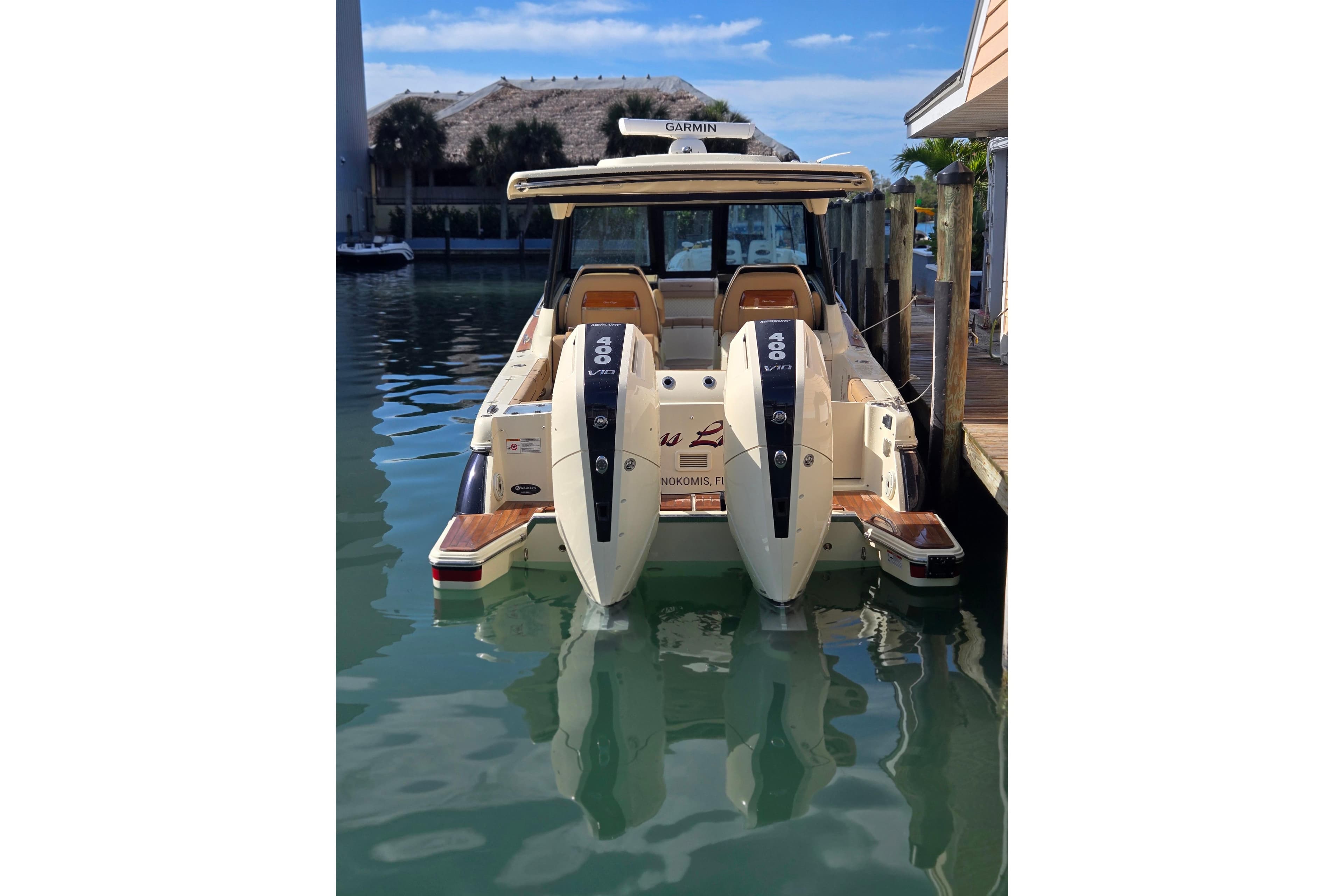 2023 Chris-Craft Calypso 35 docked, featuring dual 400 V8 engines, in a serene marina setting.