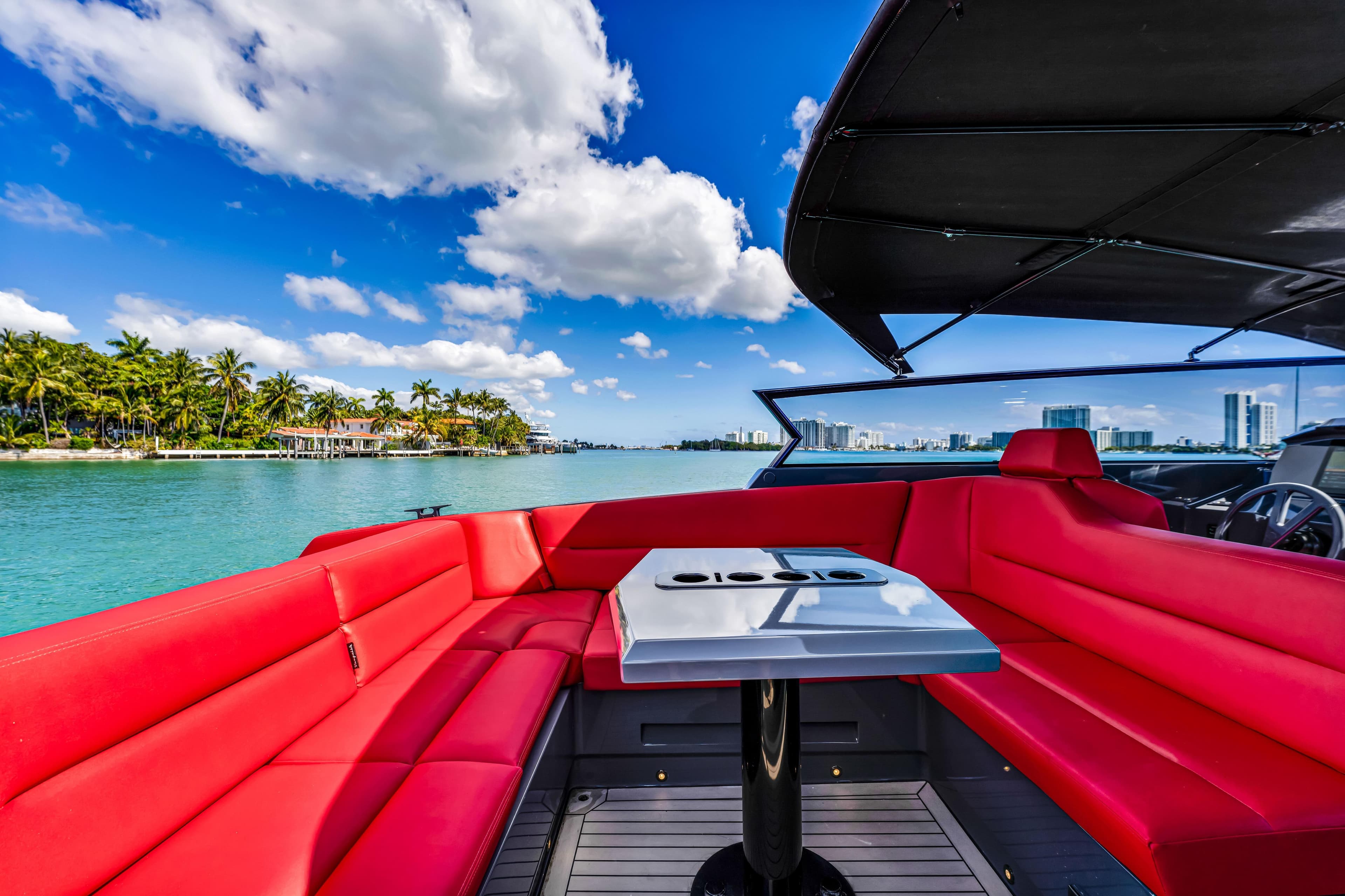 Luxurious 2021 Vanquish Yachts 45 with red seating, cruising on a sunny day.