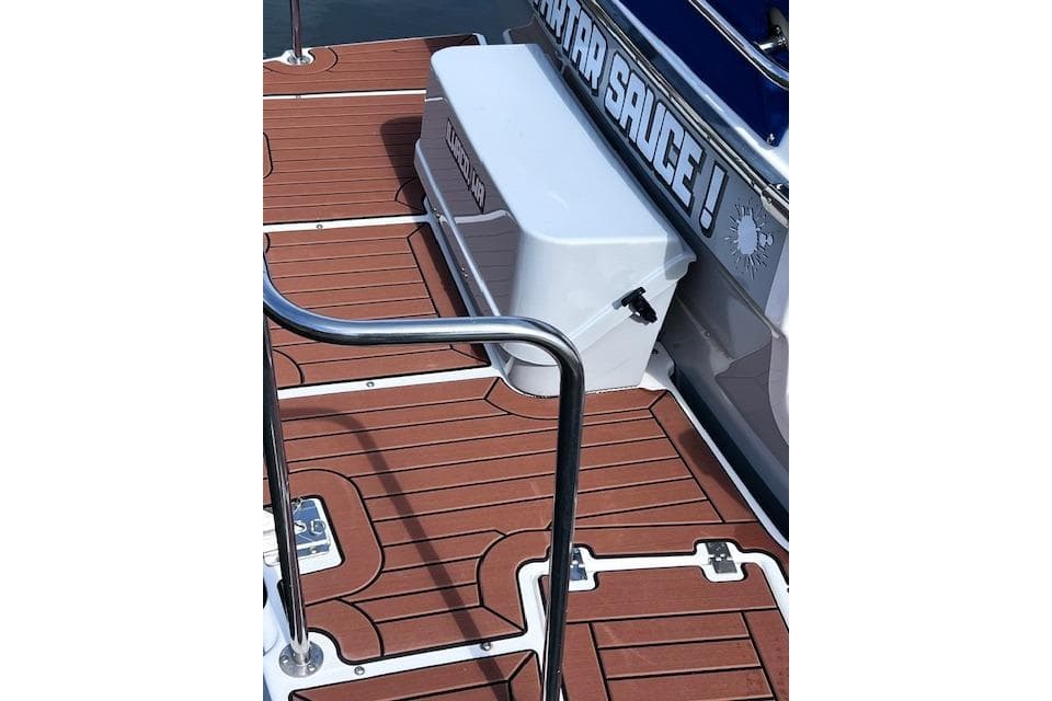 2021 Ranger Tugs R-31 CB boat deck with wooden finish and storage box.
