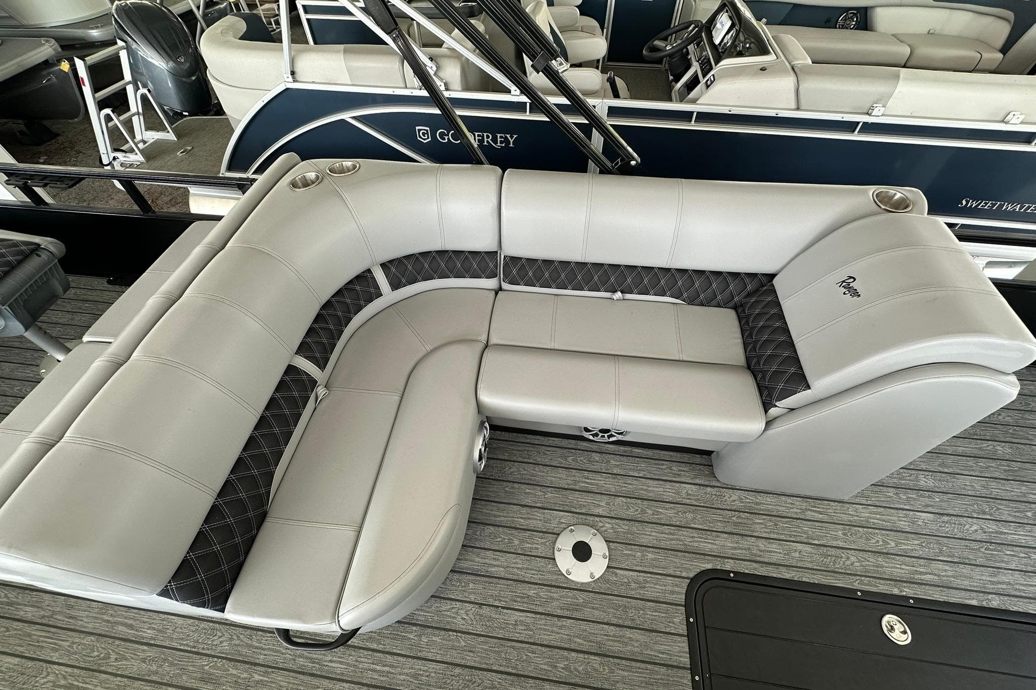 2026 Ranger Reata 223FC boat interior with gray seating and cup holders.
