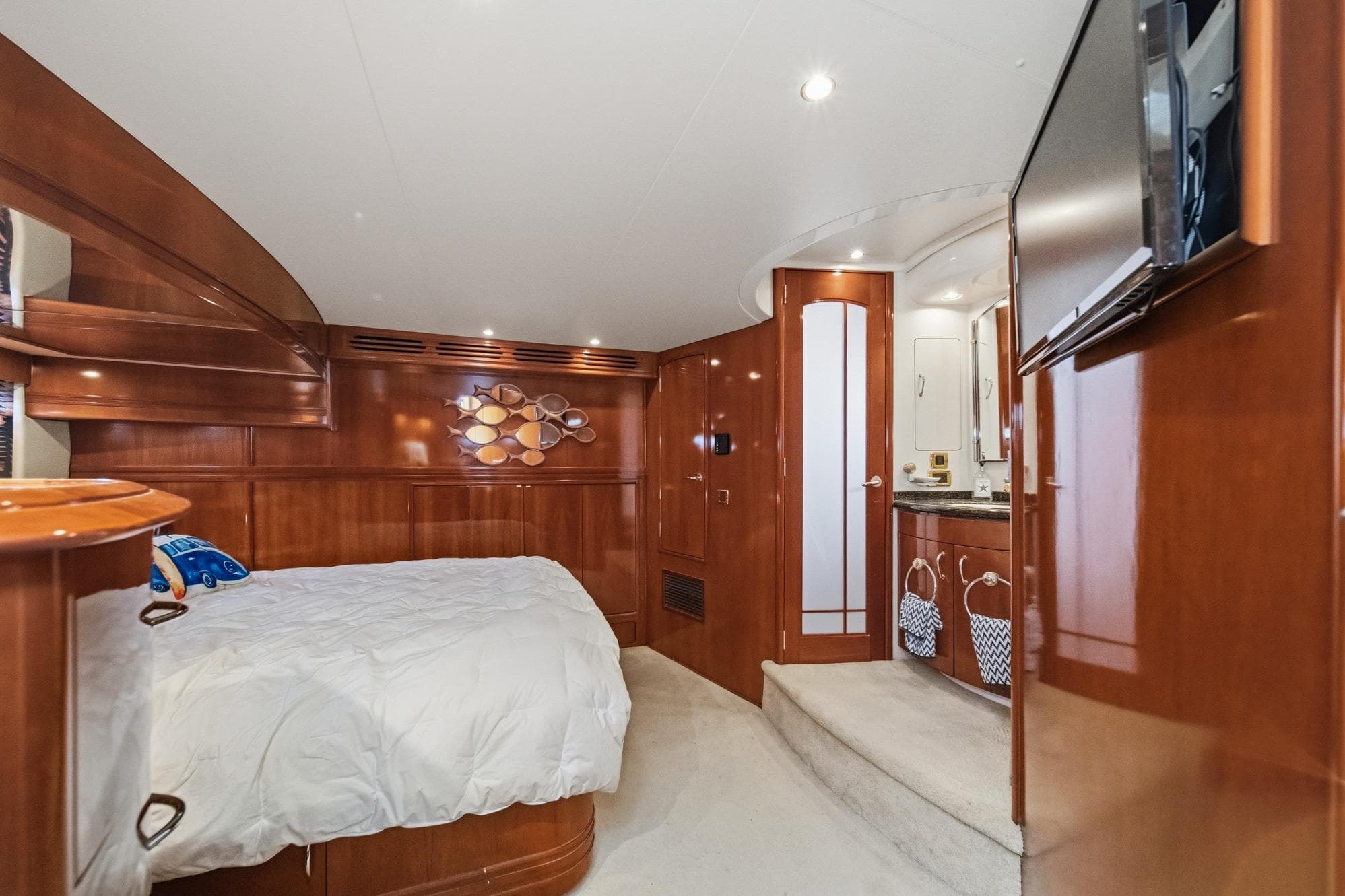 Luxurious interior of 2003 Carver 530 Voyager Pilothouse yacht bedroom with wood paneling.