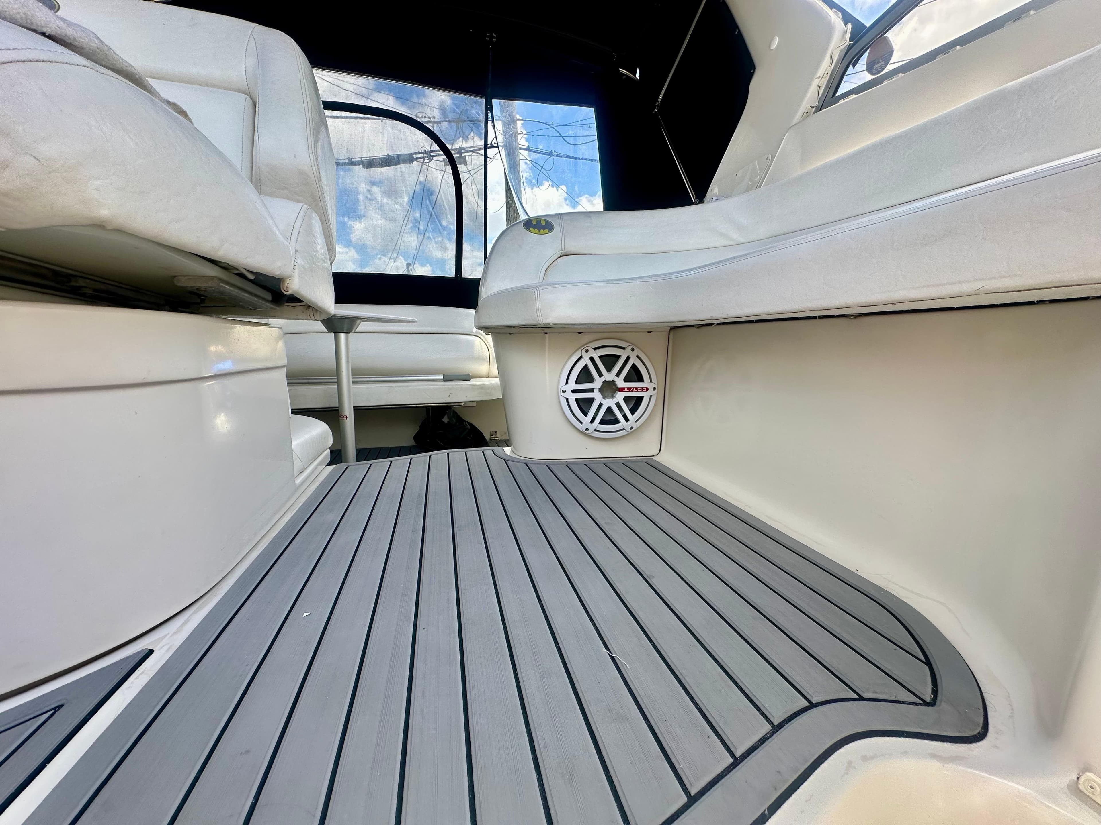 2001 Regal Commodore 2760 boat interior with cushioned seating and marine speaker.