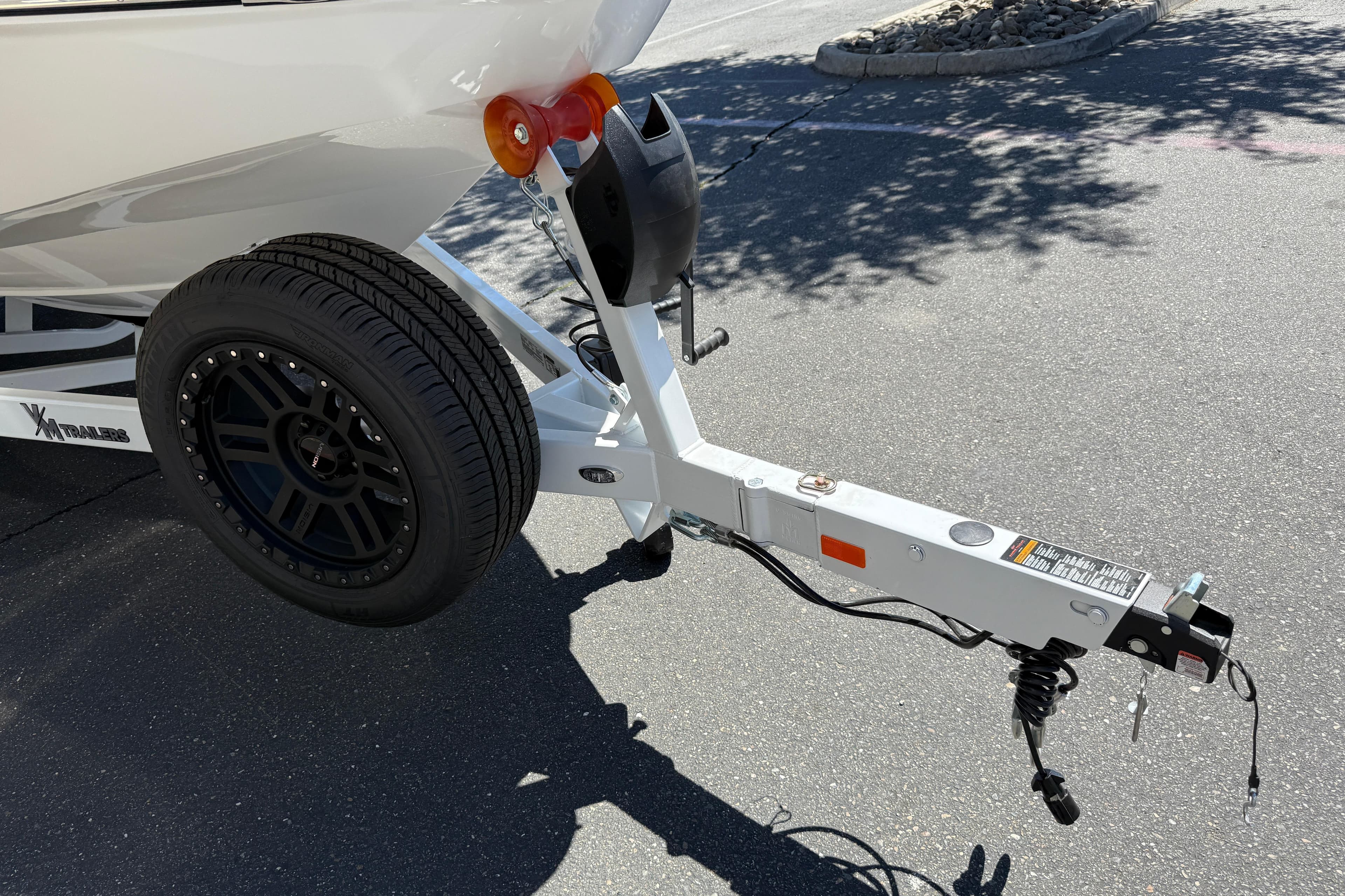 Trailer hitch of 2026 MB B52 23 Alpha boat on pavement.