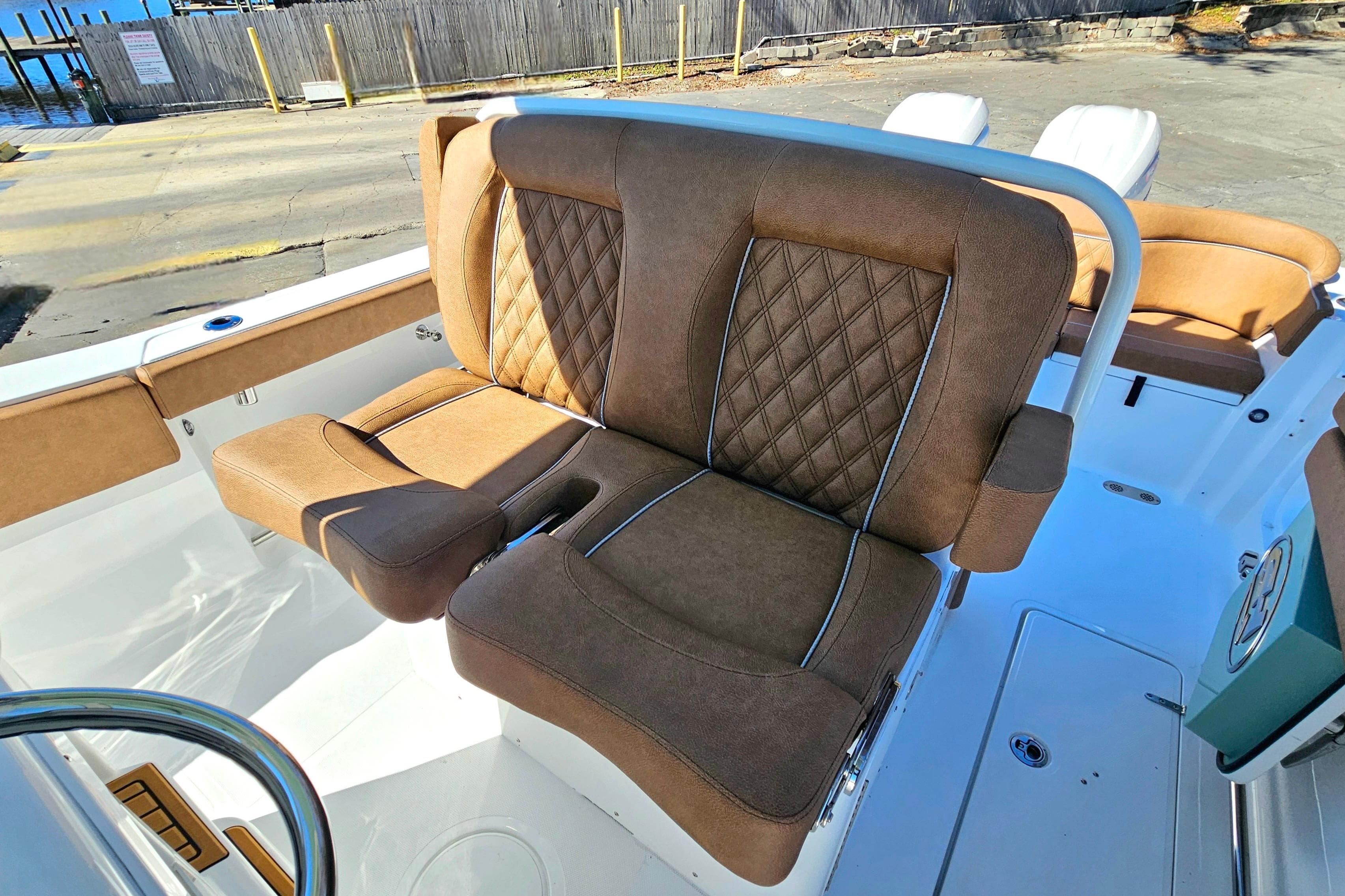 Luxurious seating on 2026 Sea Hunt Ultra 275 Coffin Box boat, featuring brown upholstery.