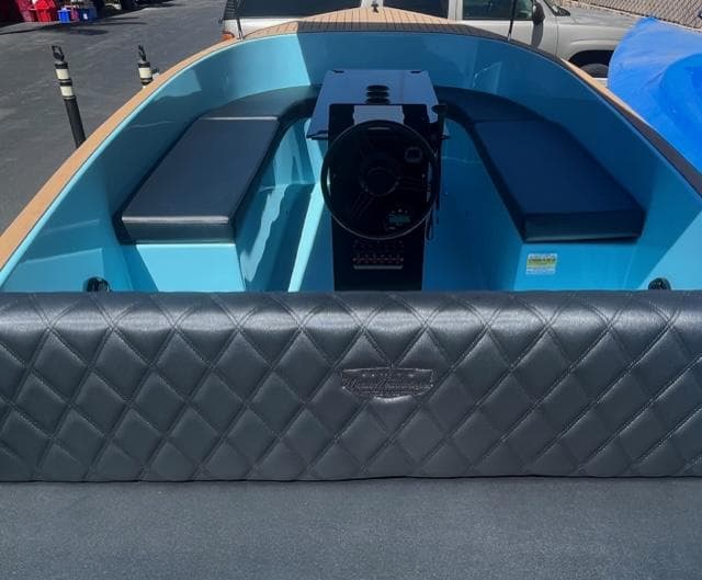 2023 Vision Marine Technologies Volt 180 boat interior with blue seating and black quilted upholstery.