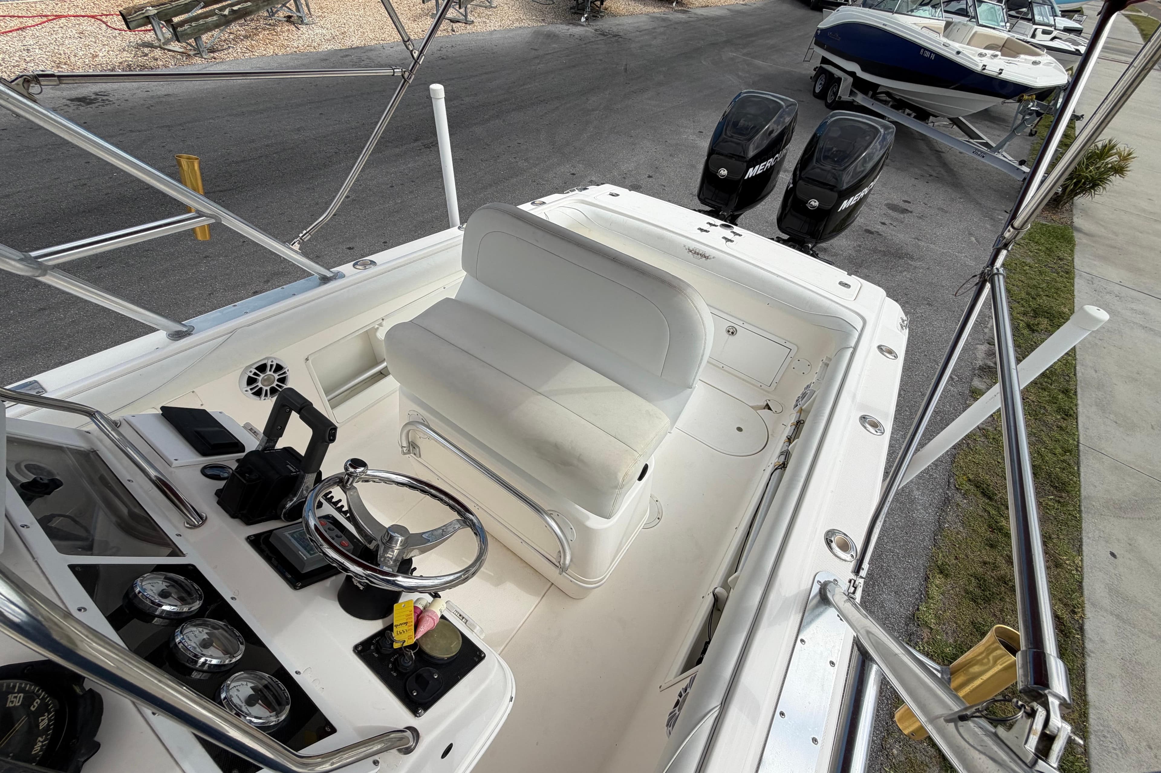 1997 Wellcraft 302 Scarab Sport boat cockpit with dual Mercury engines and steering console.