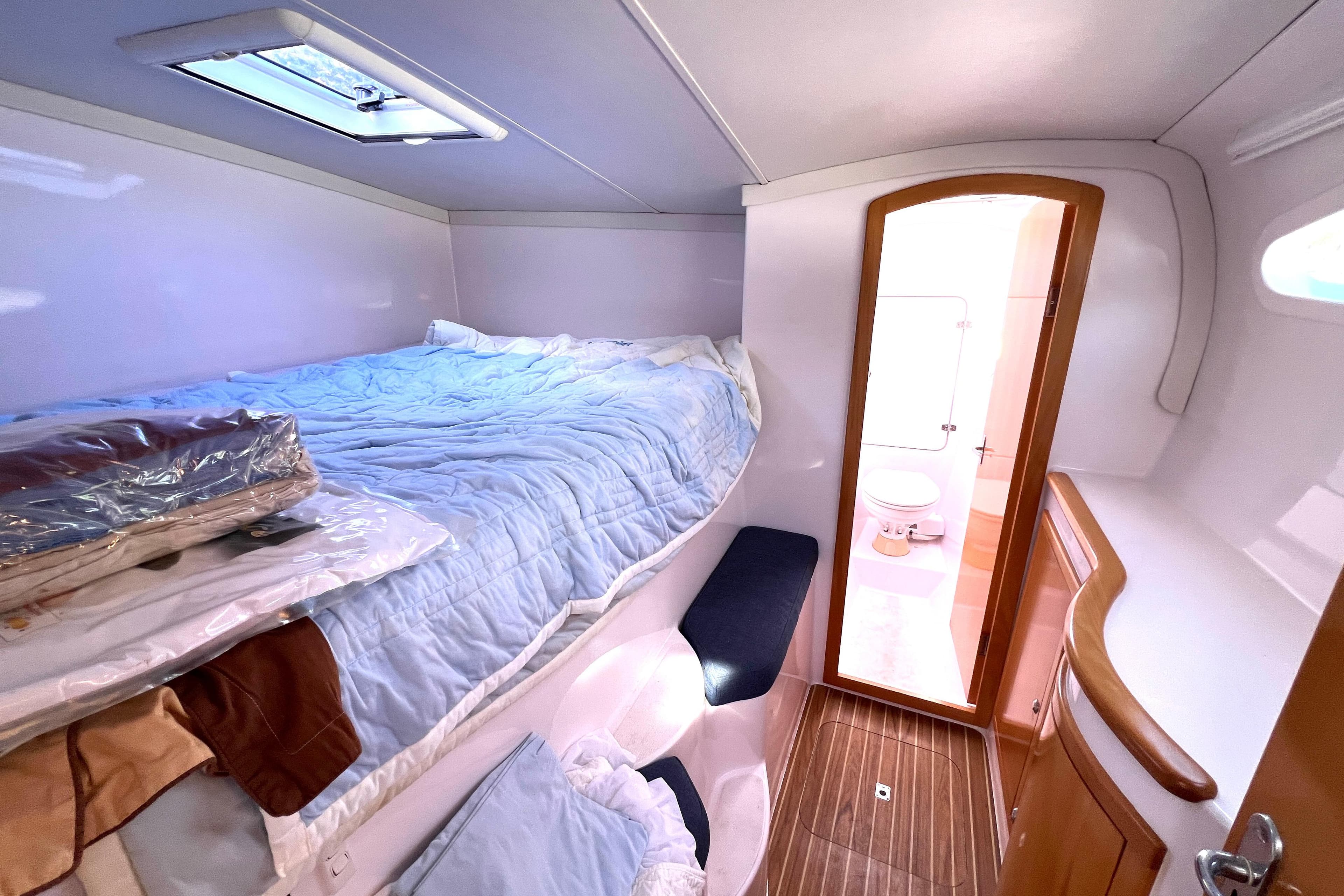 Seawind 1250 2016 yacht interior with cozy bed and compact bathroom.