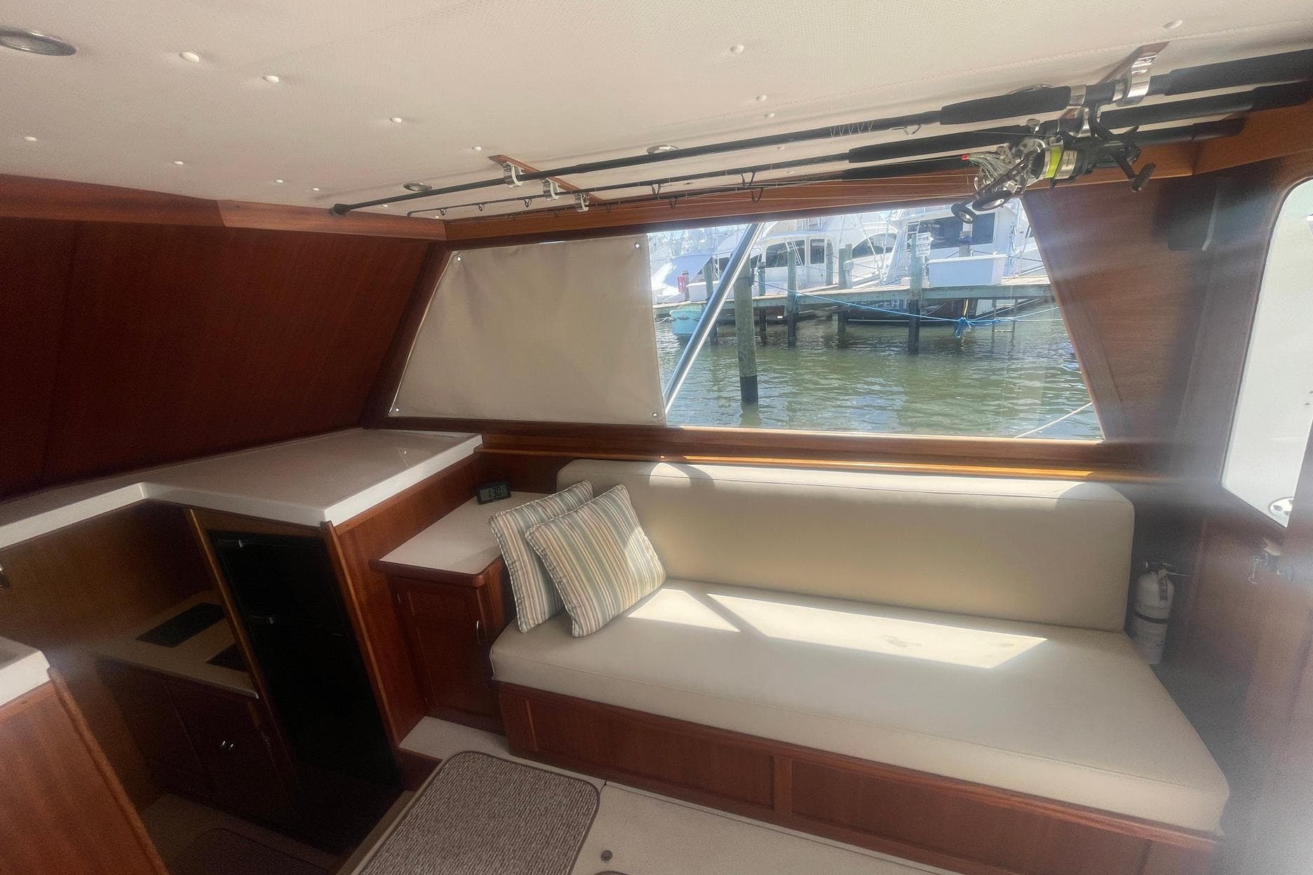 Interior of 1968 Hatteras 34 Sport Fisherman with seating and fishing rods.