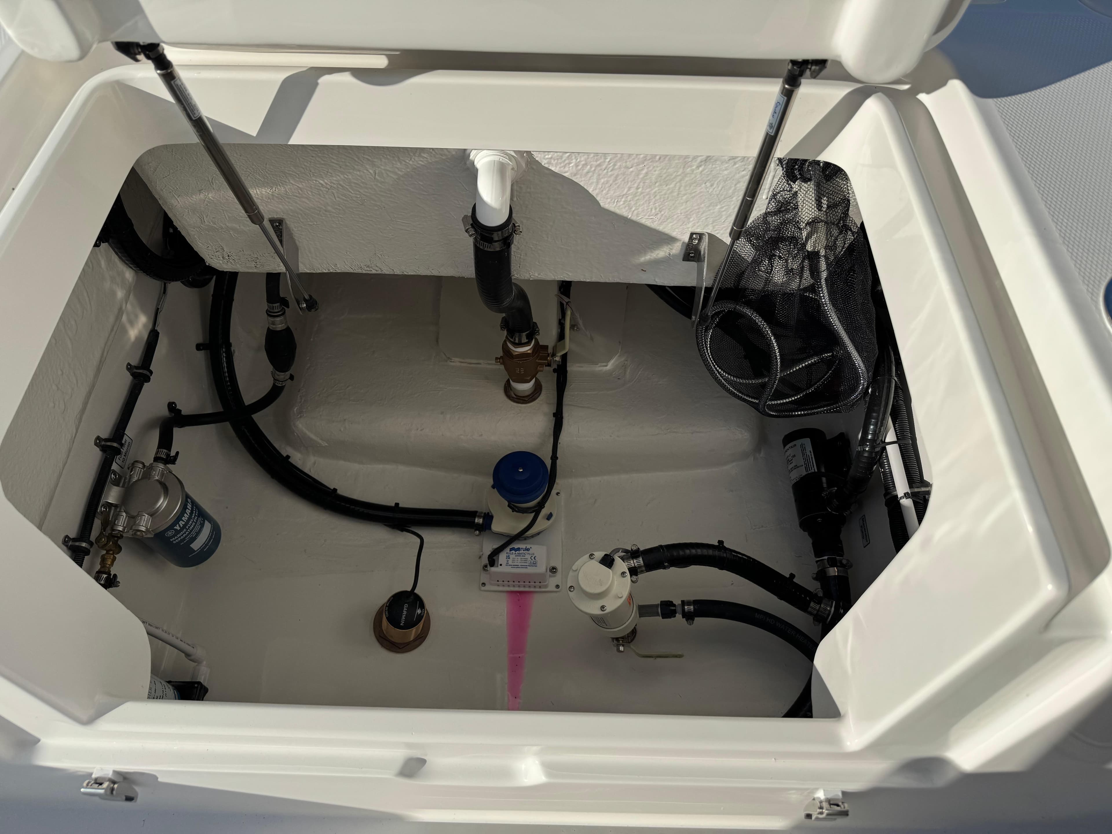 2025 Regulator 26XO boat compartment showcasing internal plumbing and storage features.