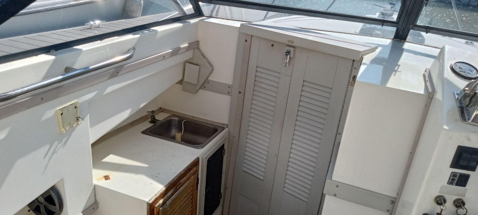 1994 Albemarle 27sf boat interior with sink and storage cabinets.