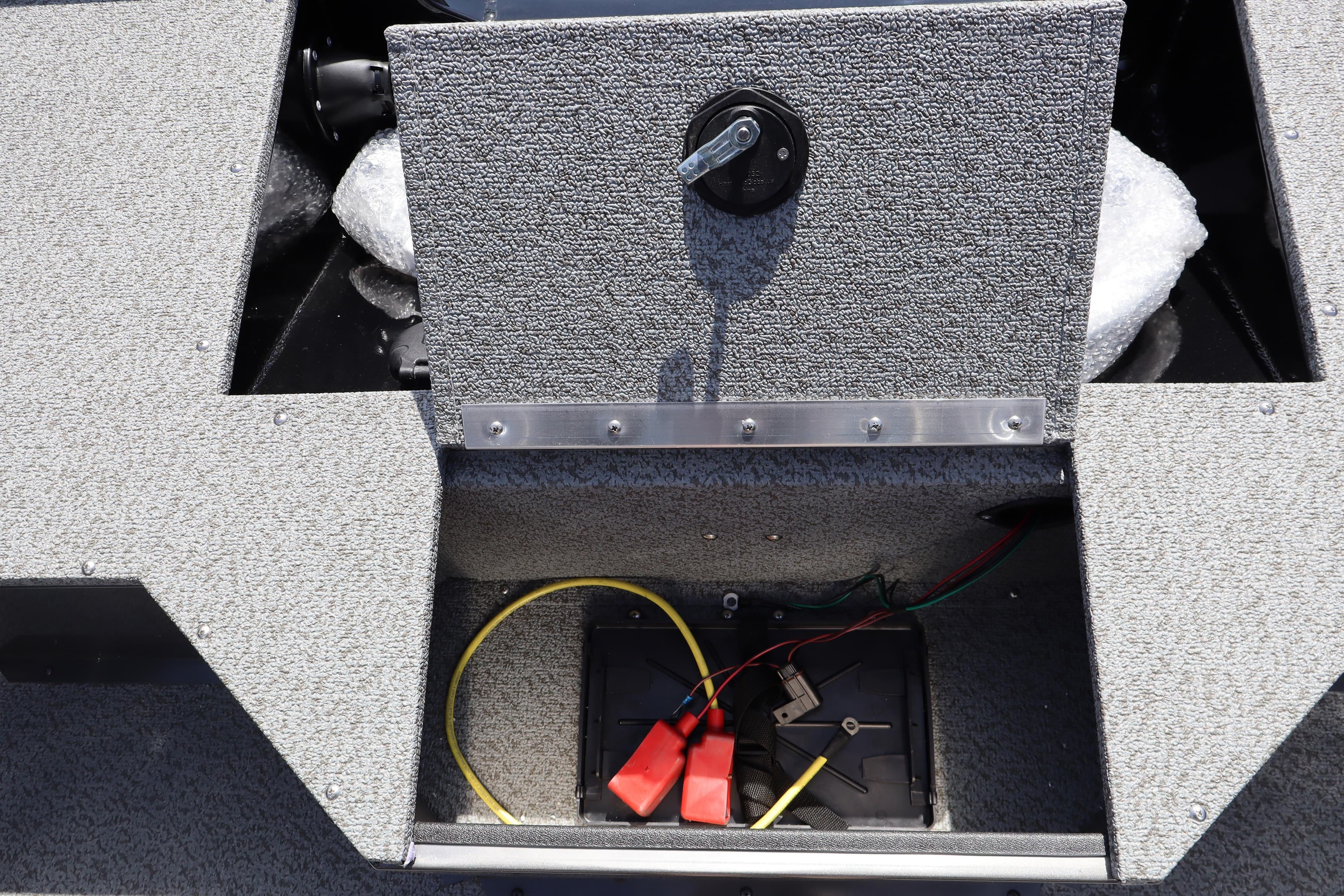2026 Smoker Craft Osprey 172 boat battery compartment with wiring and storage.