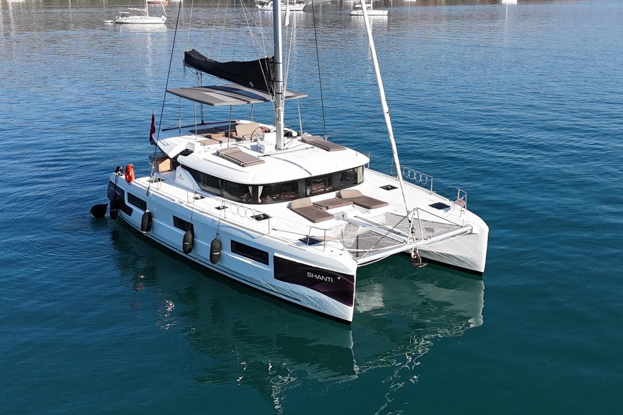 2020 Lagoon 46 catamaran sailing on calm blue waters, showcasing modern design.