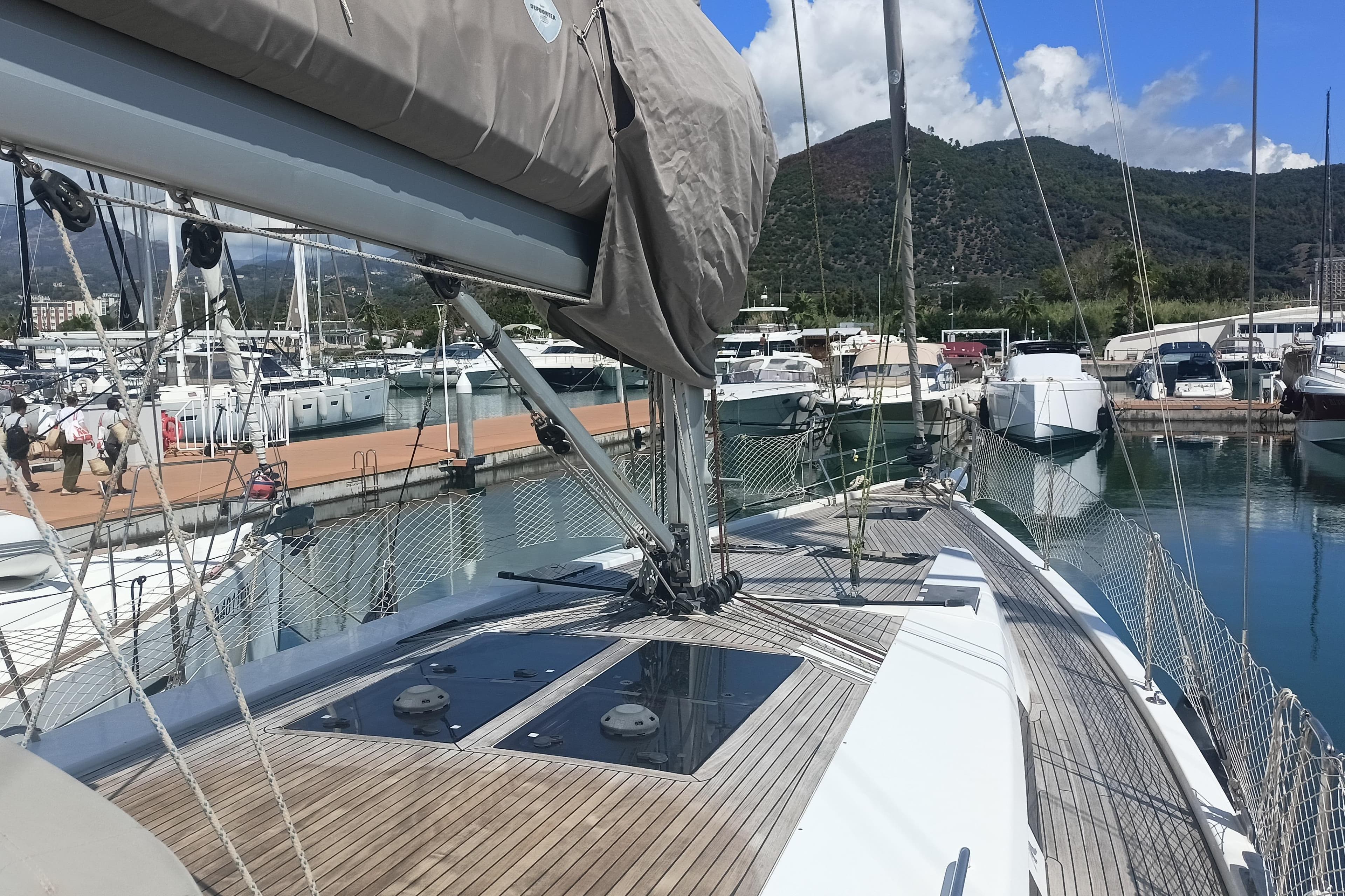 Sailing yacht Hanse 455 (2016) docked in a marina with scenic mountain backdrop.