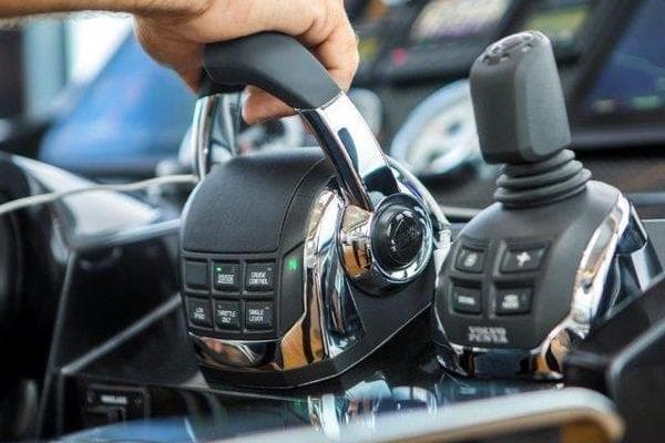 Hand operating controls on 2021 OKEAN FB Motor Yacht dashboard.