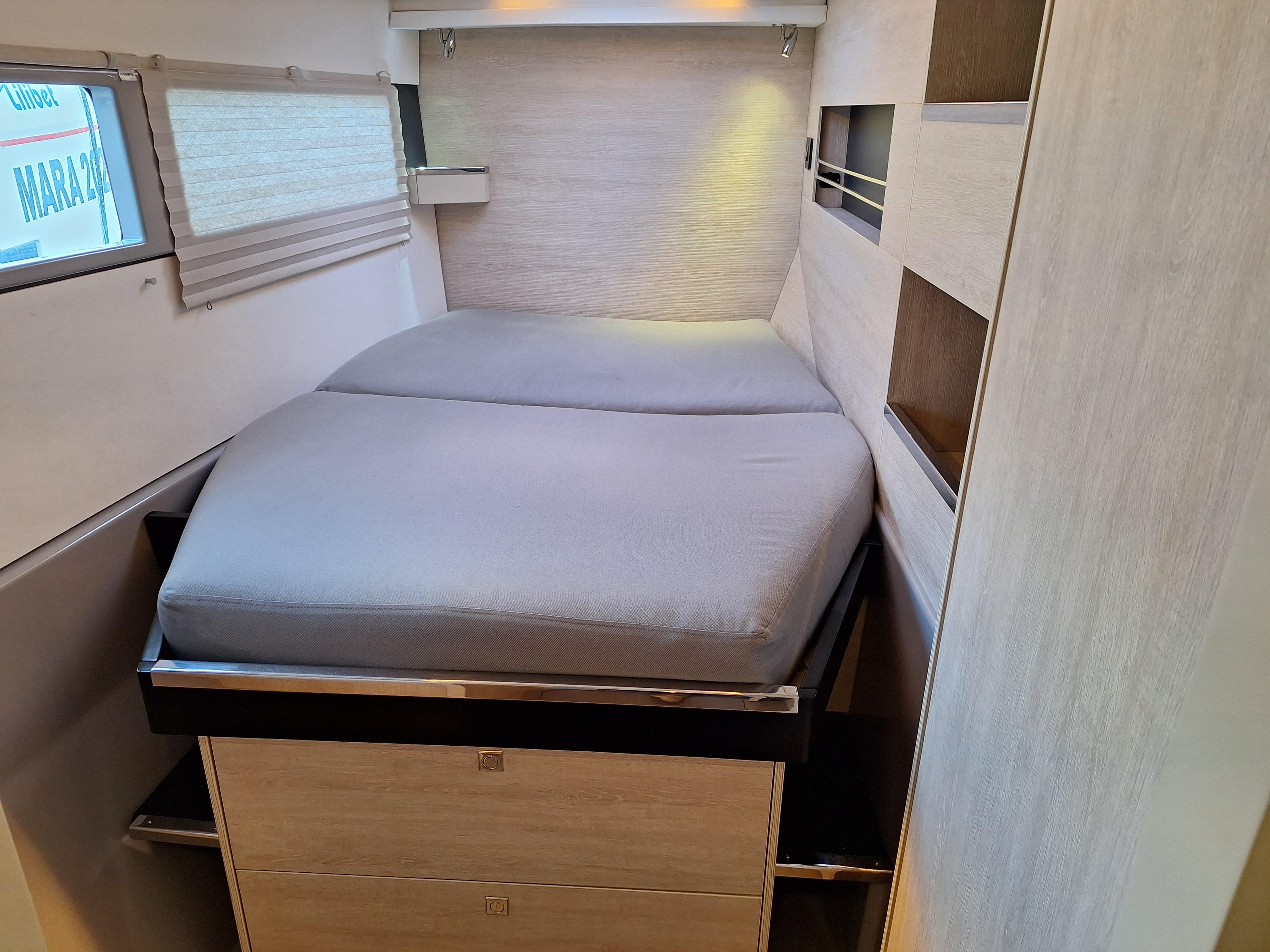 Cozy bedroom in 2019 Leopard 45 yacht with modern design and ample storage.