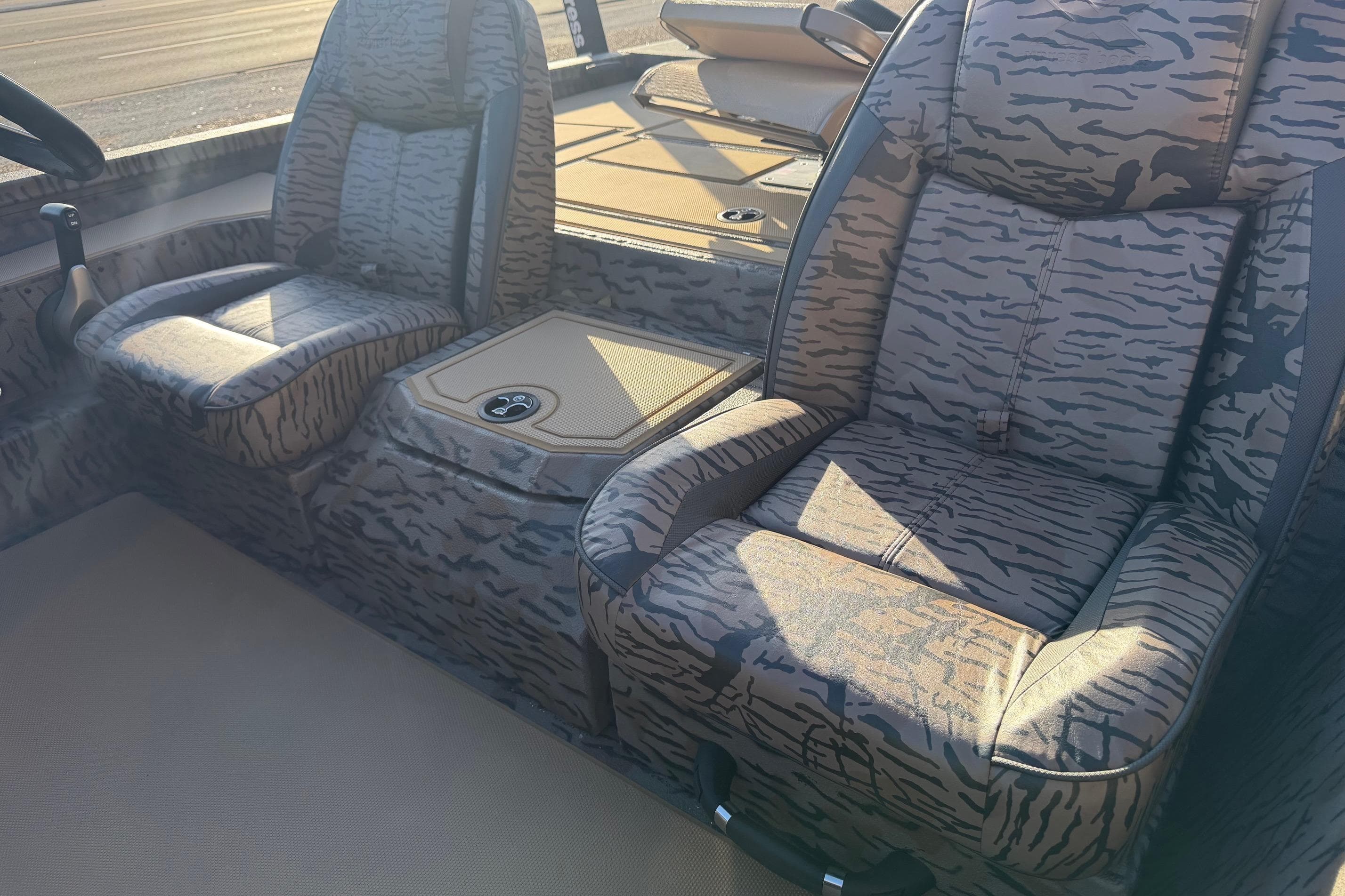 2026 Xpress H20C Crappie boat interior with camo-patterned seats and console.