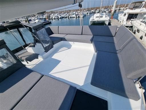 2022 Fountaine Pajot Tanna 47 catamaran with spacious deck and seating in marina.
