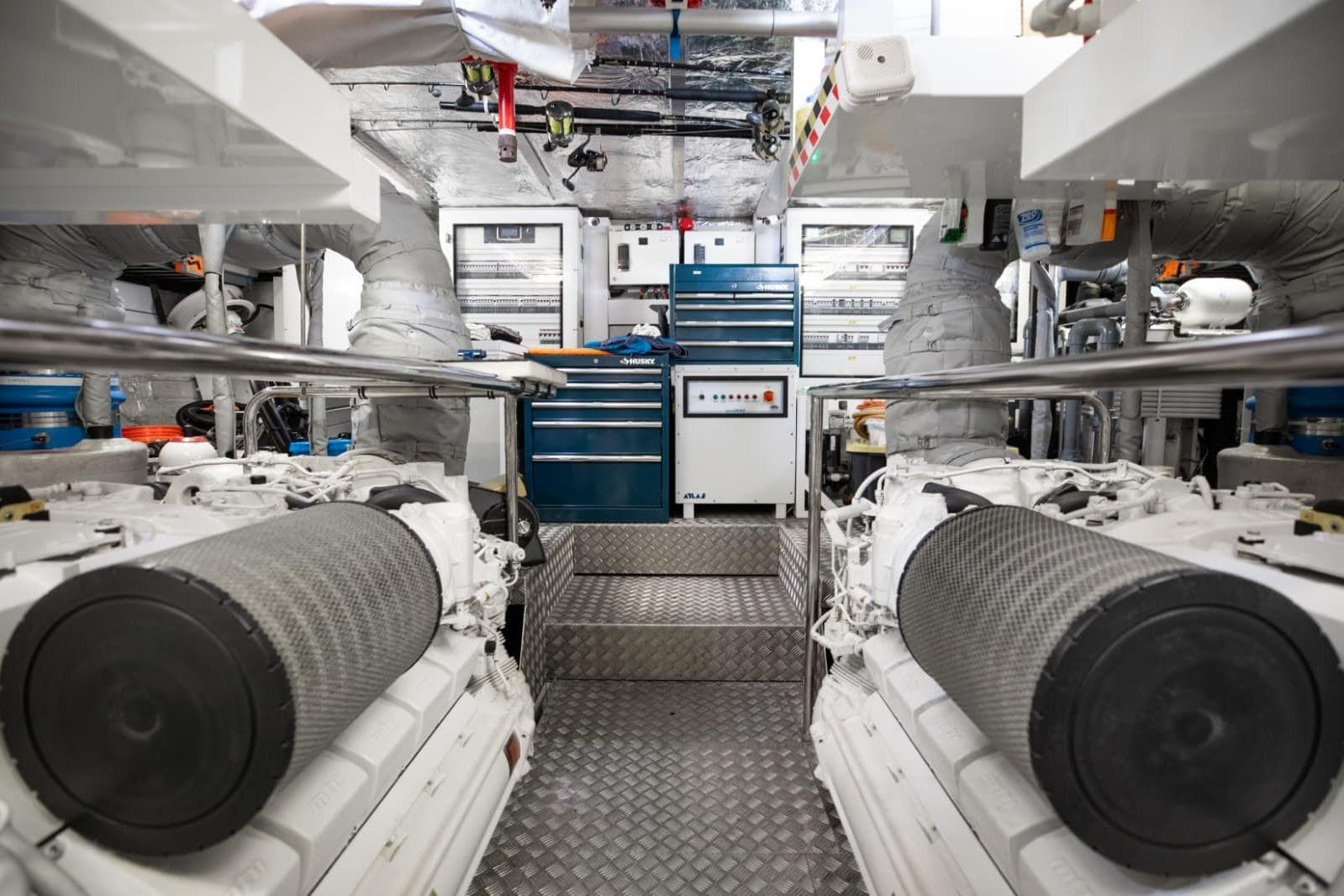 Engine room of 2018 Sunseeker 95 Yacht, featuring dual engines and organized tool storage.