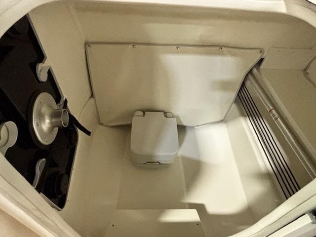 Interior of 2025 Bayliner T22 SC boat, featuring compact storage space.