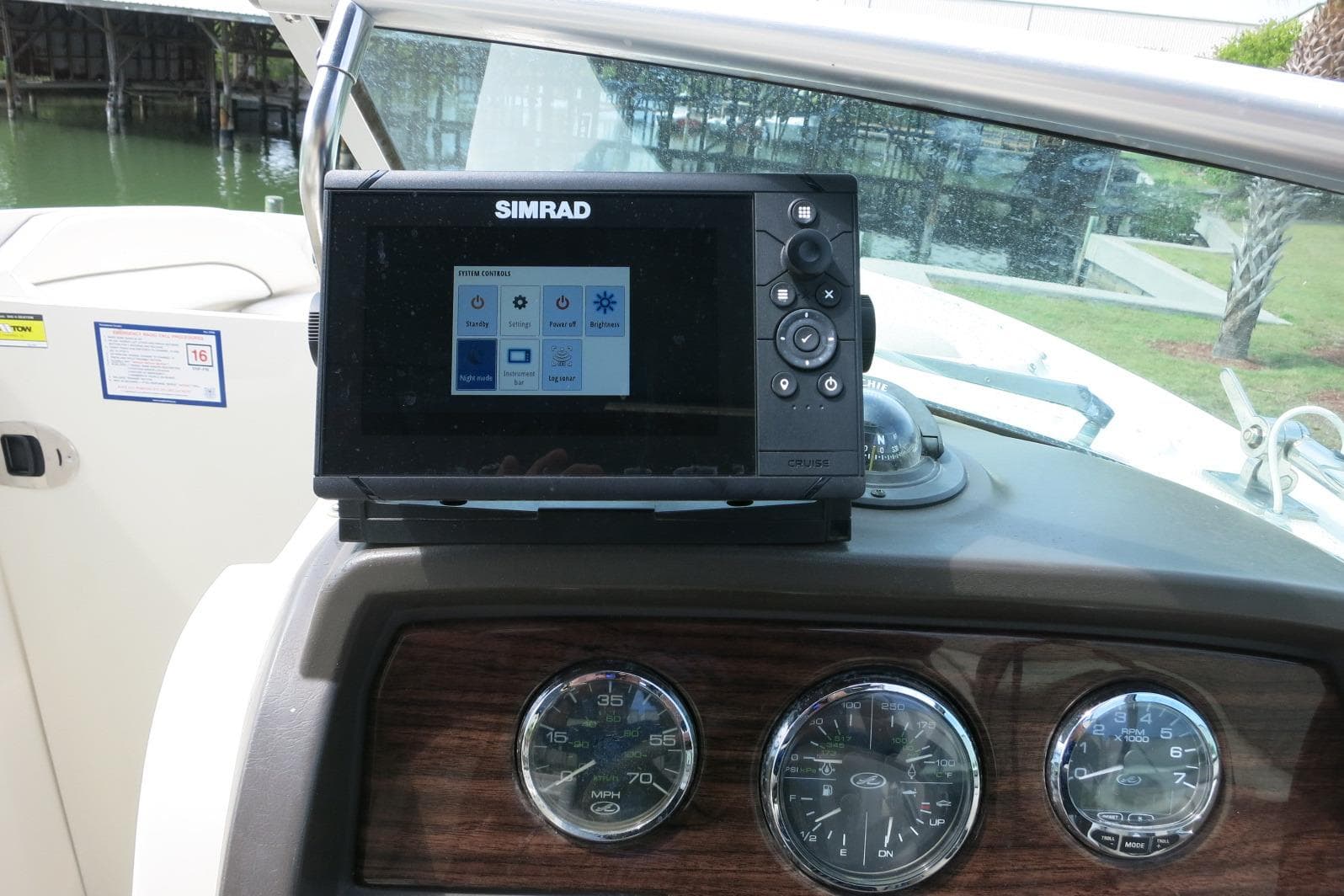 Simrad navigation system on 2008 Sea Ray 260 Sundeck dashboard with gauges.