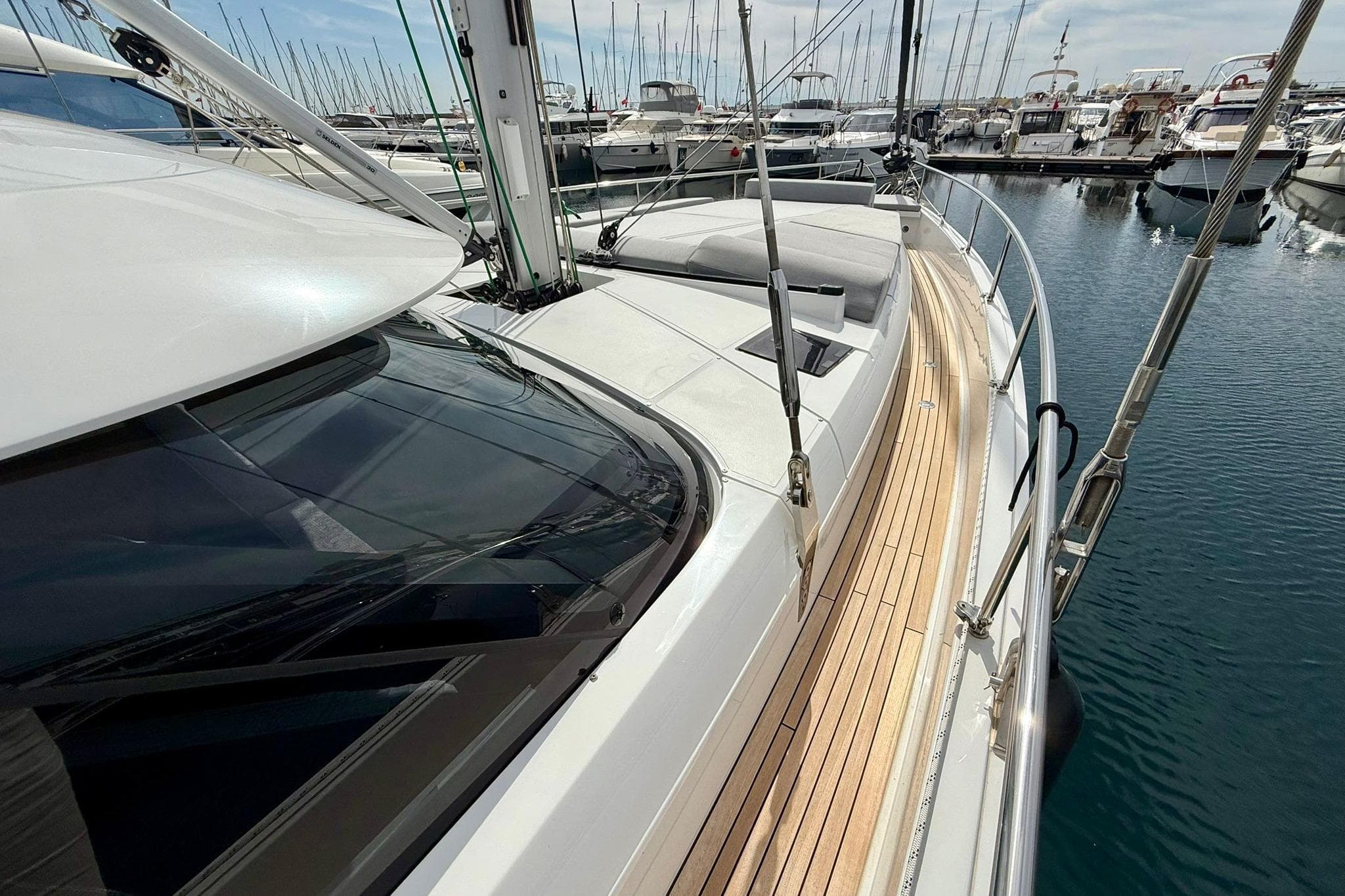 Luxurious 2025 Moody DS48 yacht docked in marina, showcasing sleek design and spacious deck.