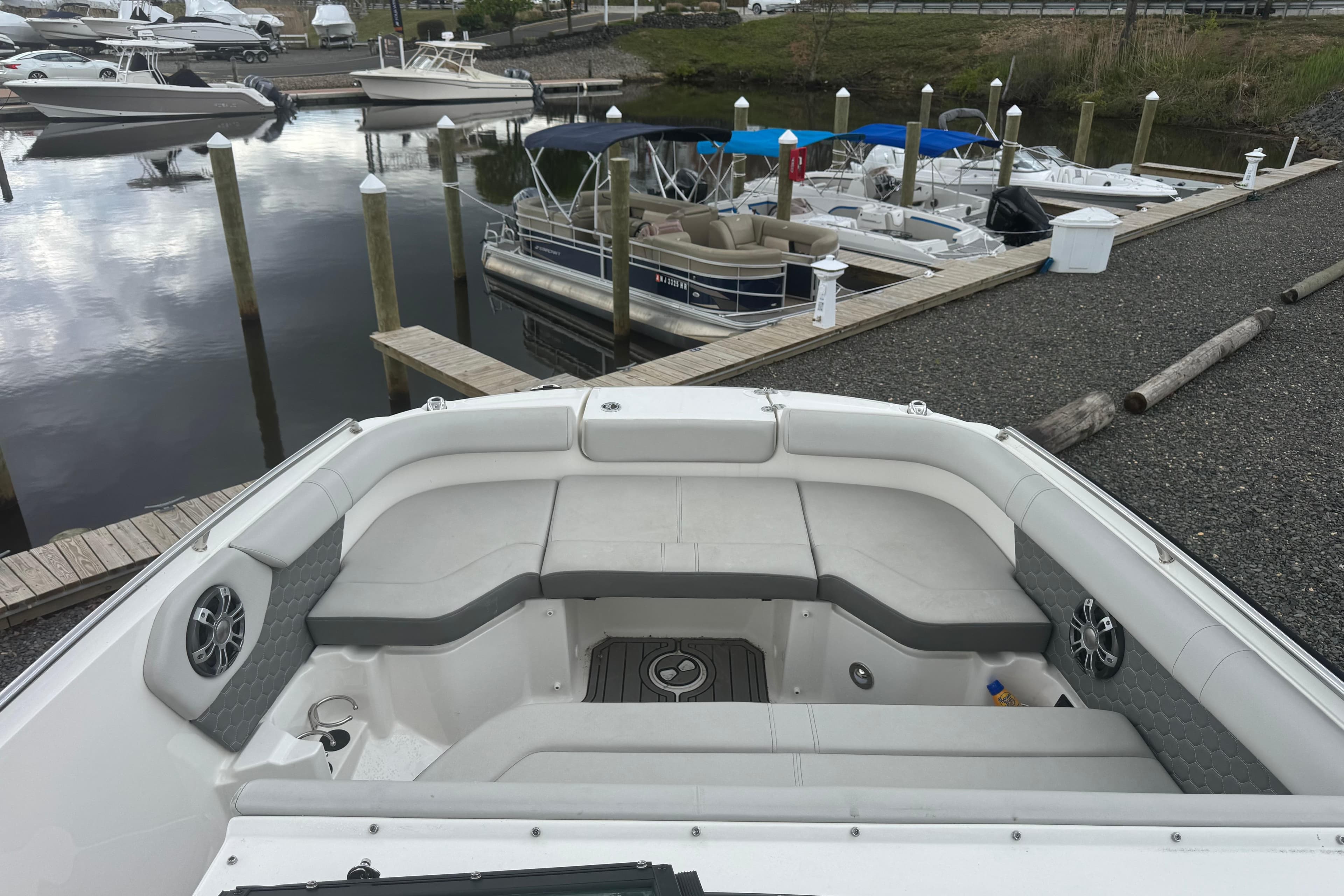 2024 Sea Ray SDX 250 Outboard boat docked, featuring spacious seating and modern design.