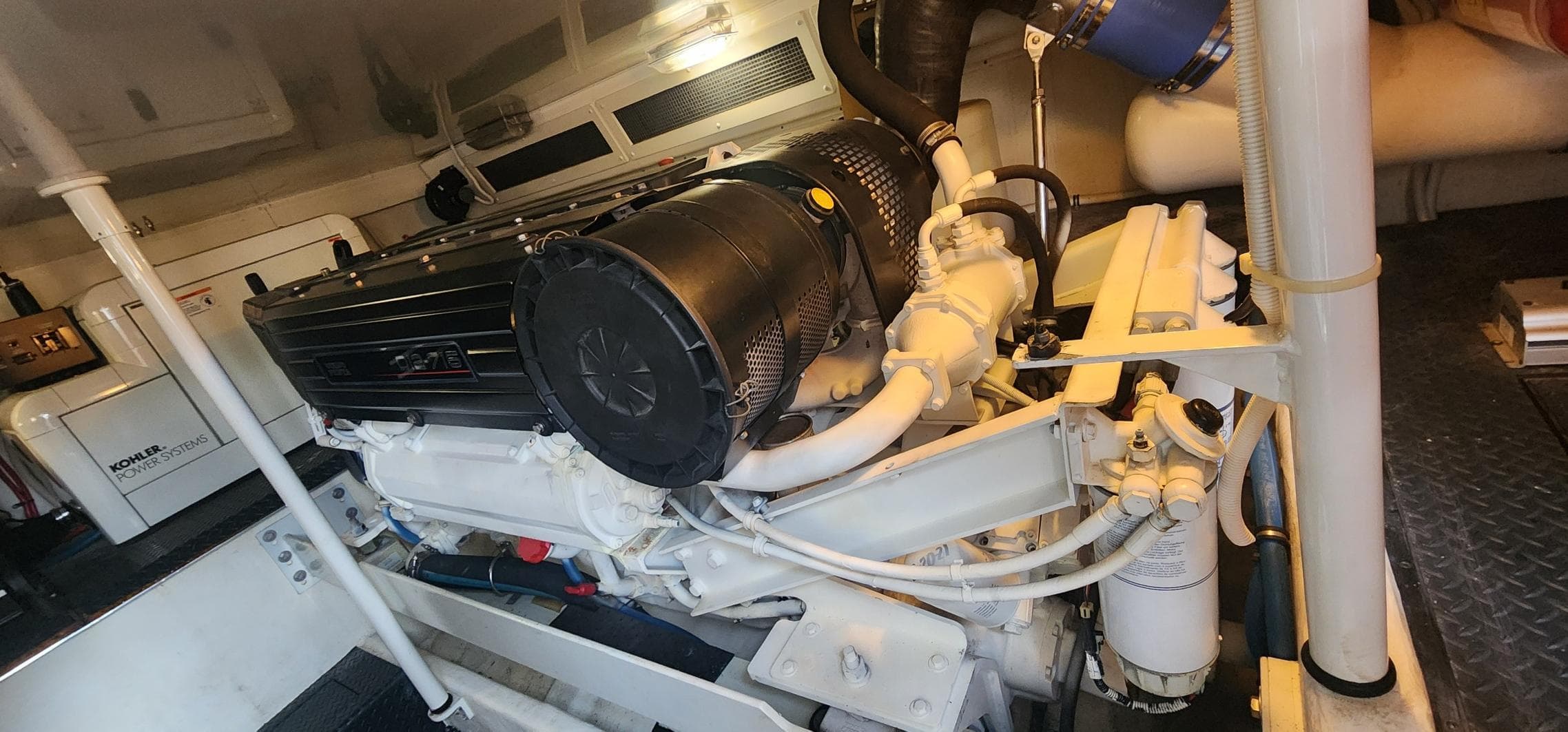 Engine room of a 2004 Silverton 48 Convertible yacht, showcasing detailed machinery.