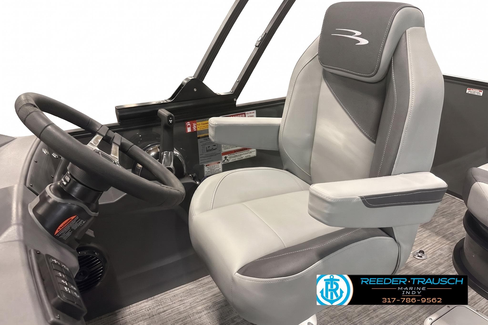 Captain's seat and steering wheel of 2026 Bennington 22 SSB boat, featuring modern design.