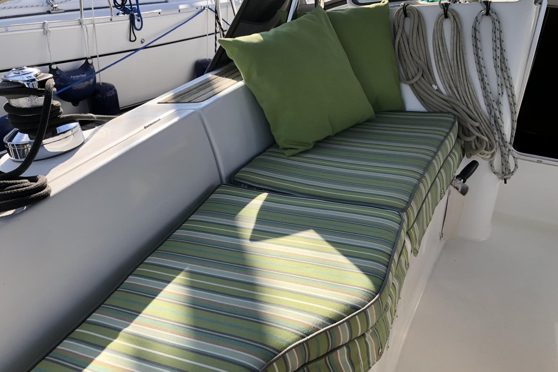 Beneteau Oceanis 361 sailboat cockpit with striped cushions and green pillows, 2001 model.