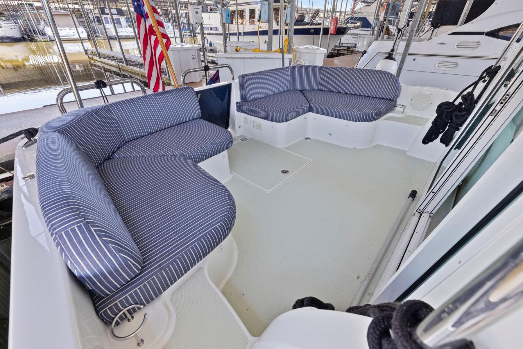 2018 Back Cove 32 boat deck with striped seating and American flag.