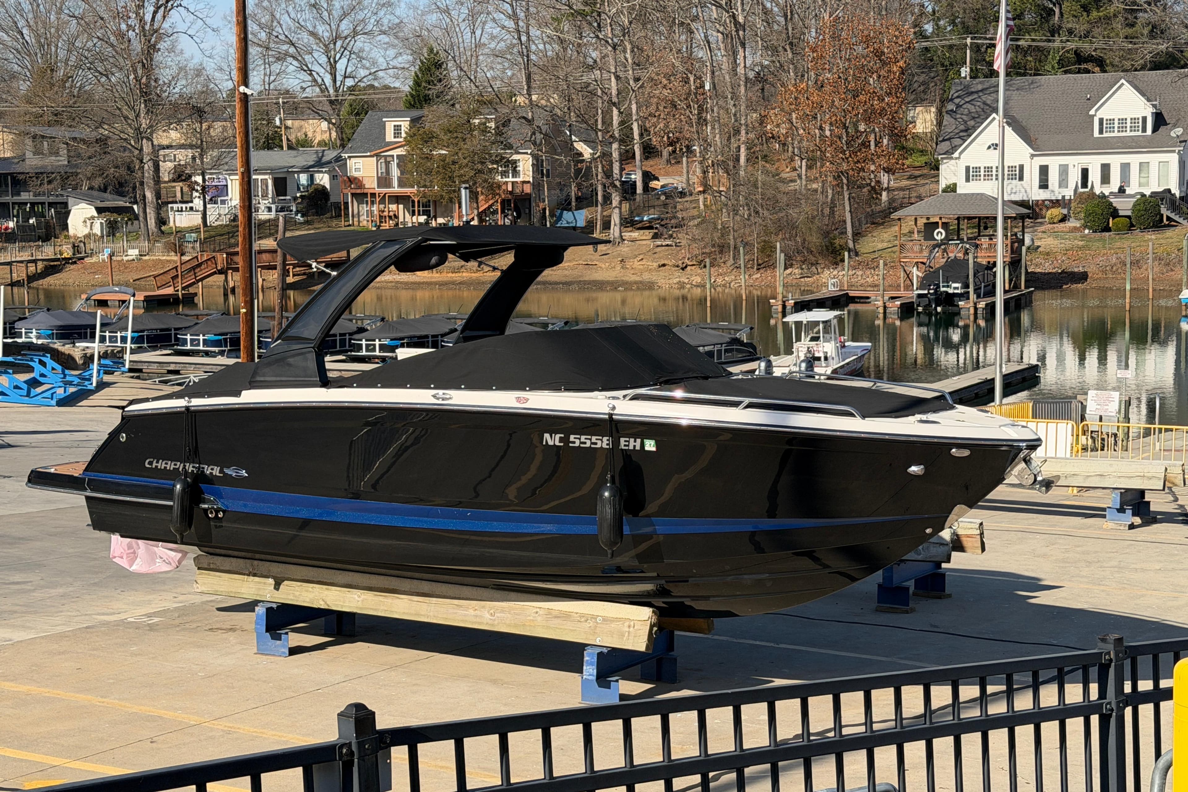 2018 Chaparral 267 SSX boat on a dock, with a scenic waterfront background.