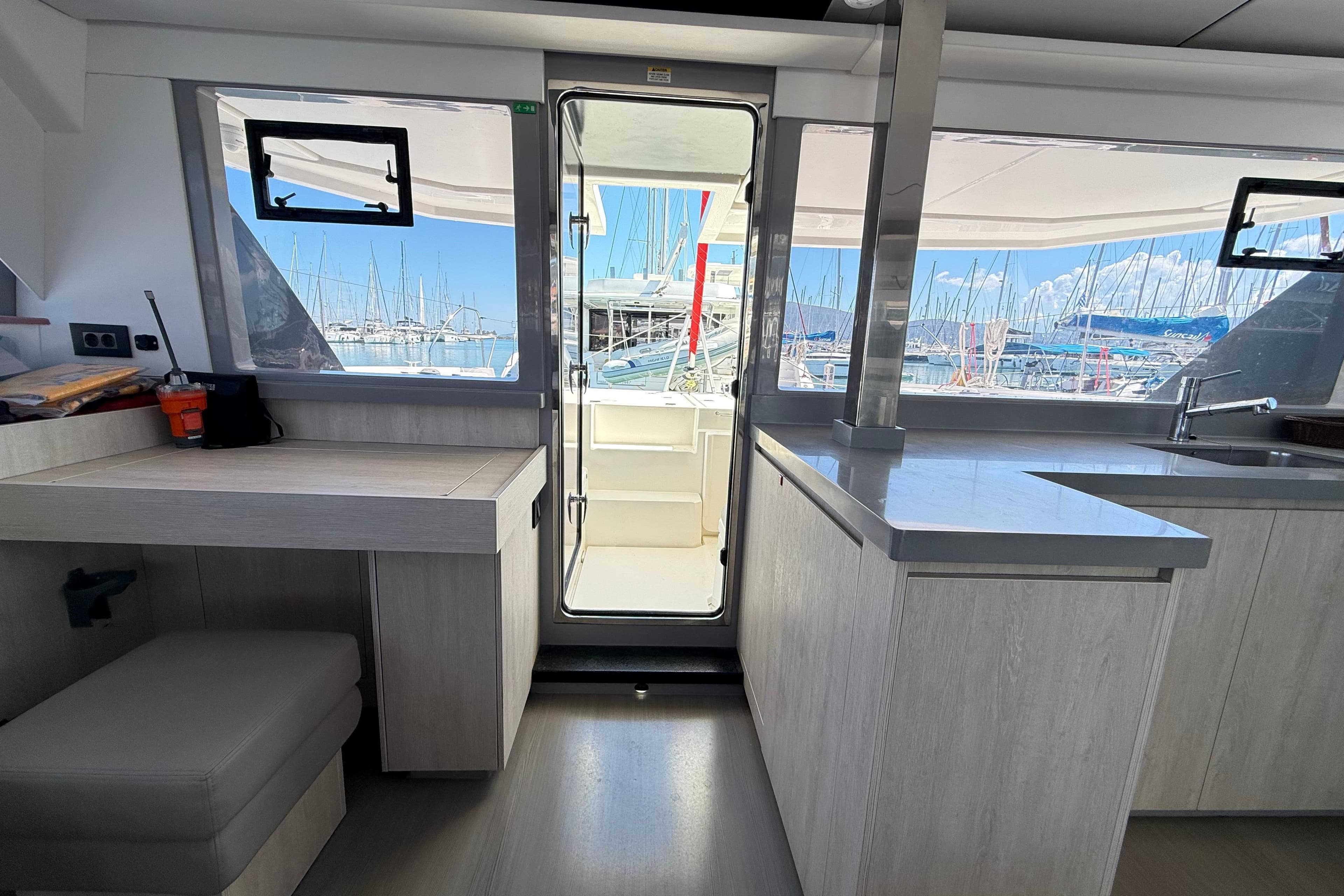 Interior of 2021 Leopard 45 catamaran with modern kitchen and marina view.