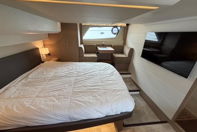 Luxurious cabin interior of a 2017 Prestige 500S yacht with bed and seating area.