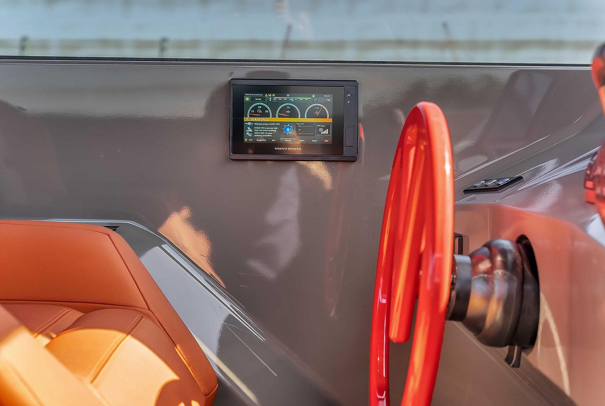 Interior of 2021 Vanquish Yachts VQ 45 with red steering wheel and digital display.