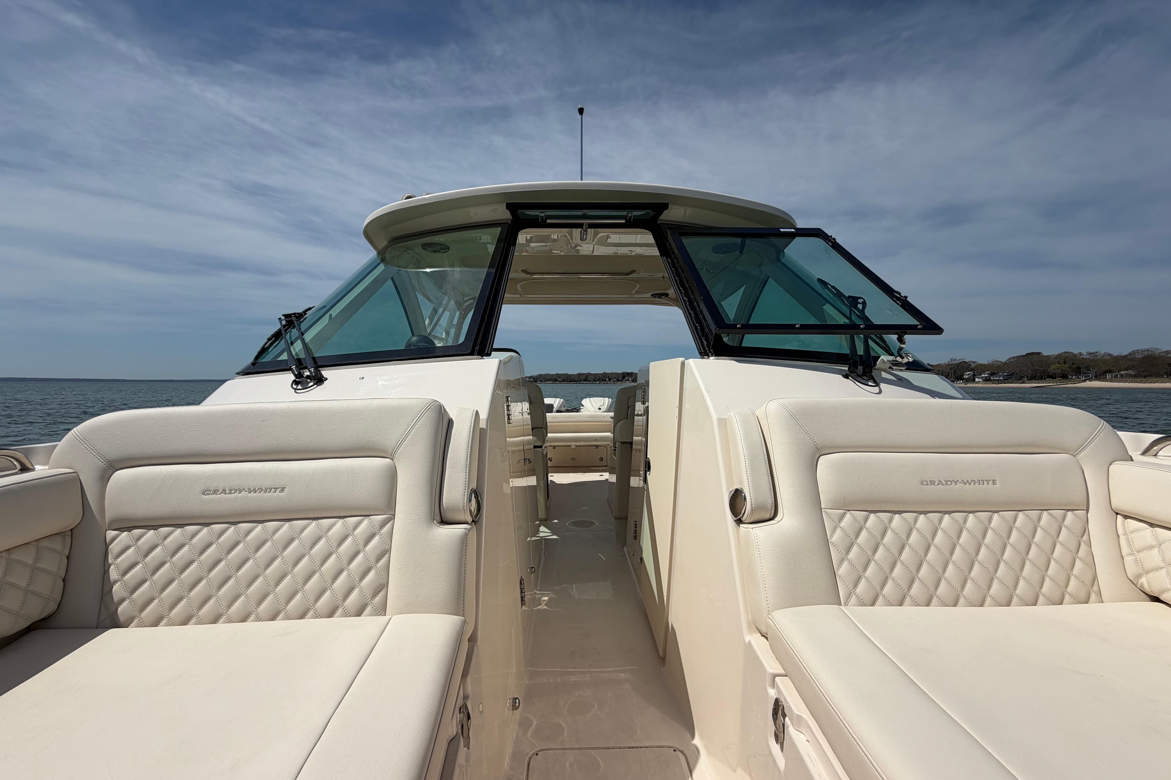 2026 Grady-White Freedom 325 boat with luxurious seating and open sea view.