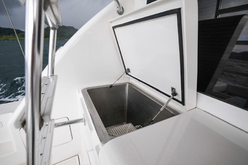 Open storage compartment on 2009 Bertram 510 yacht, featuring stainless steel interior.