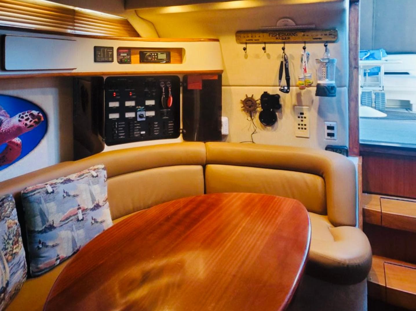 Interior of 1994 Sea Ray 400 Express Cruiser with cozy seating and control panel.