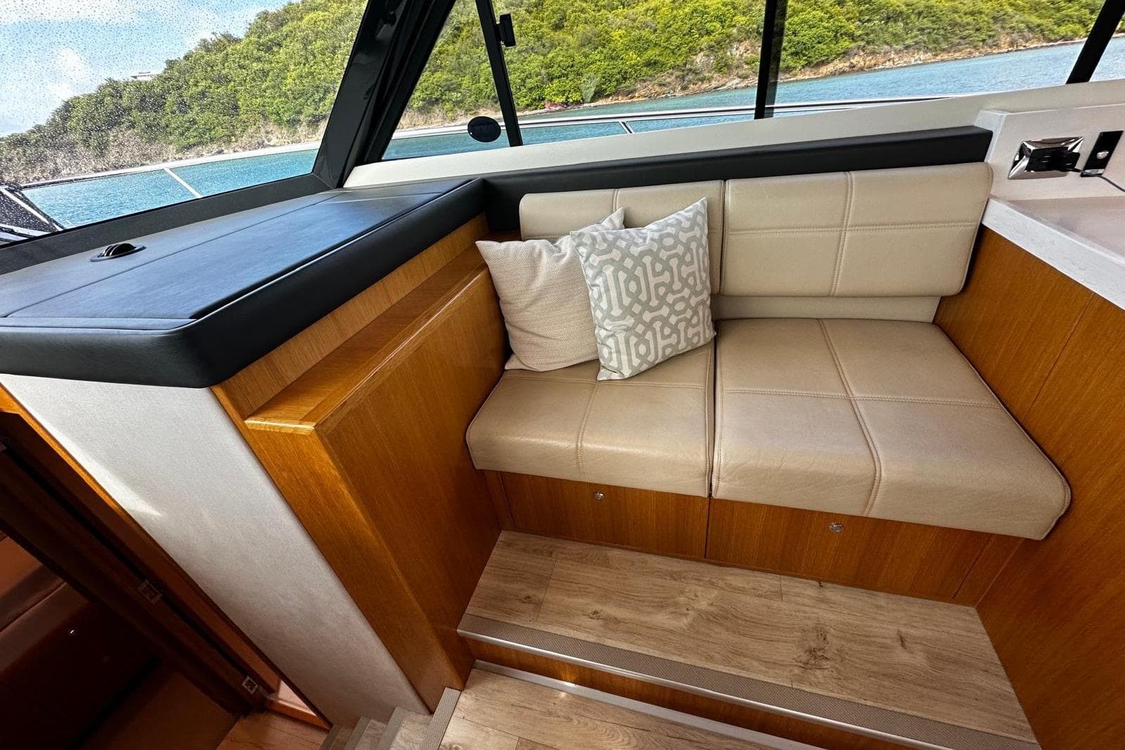 Luxurious interior seating of 2020 Riviera 395 SUV yacht with scenic ocean view.