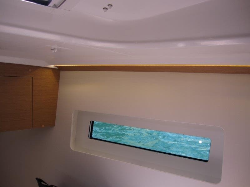 Interior view of 2025 Jeanneau Sun Odyssey 350 yacht cabin with window.