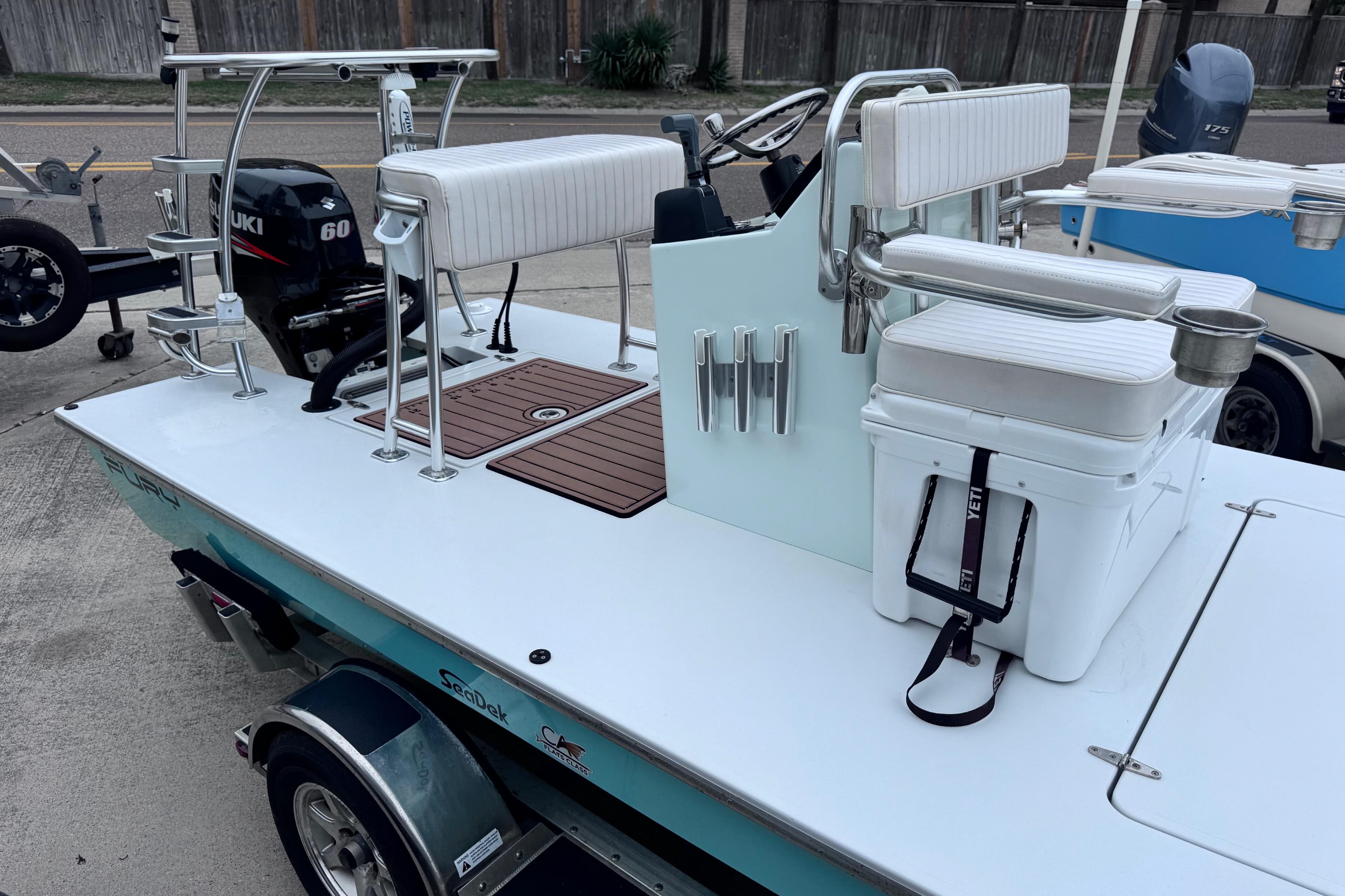 2016 East Cape Fury boat with Suzuki 60 engine, featuring a sleek deck and seating.