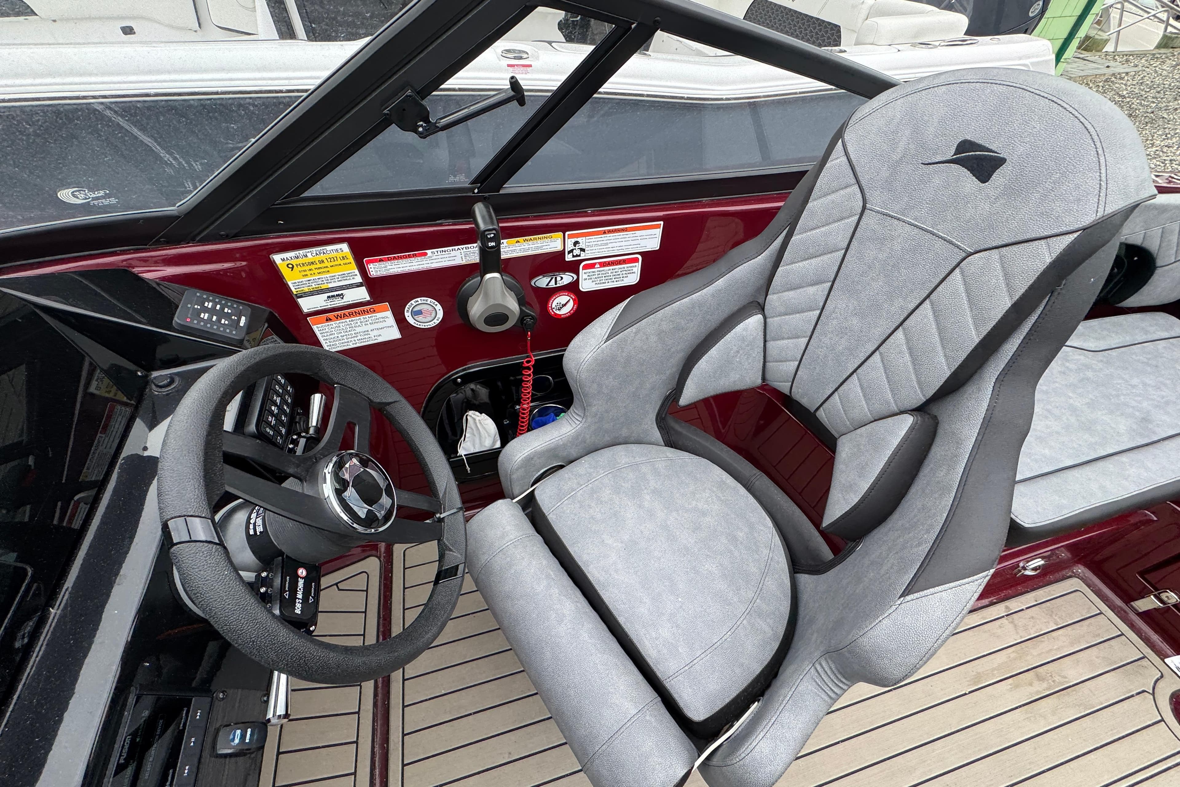 2026 Stingray 23 OCX boat interior with sleek steering wheel and modern captain's chair.