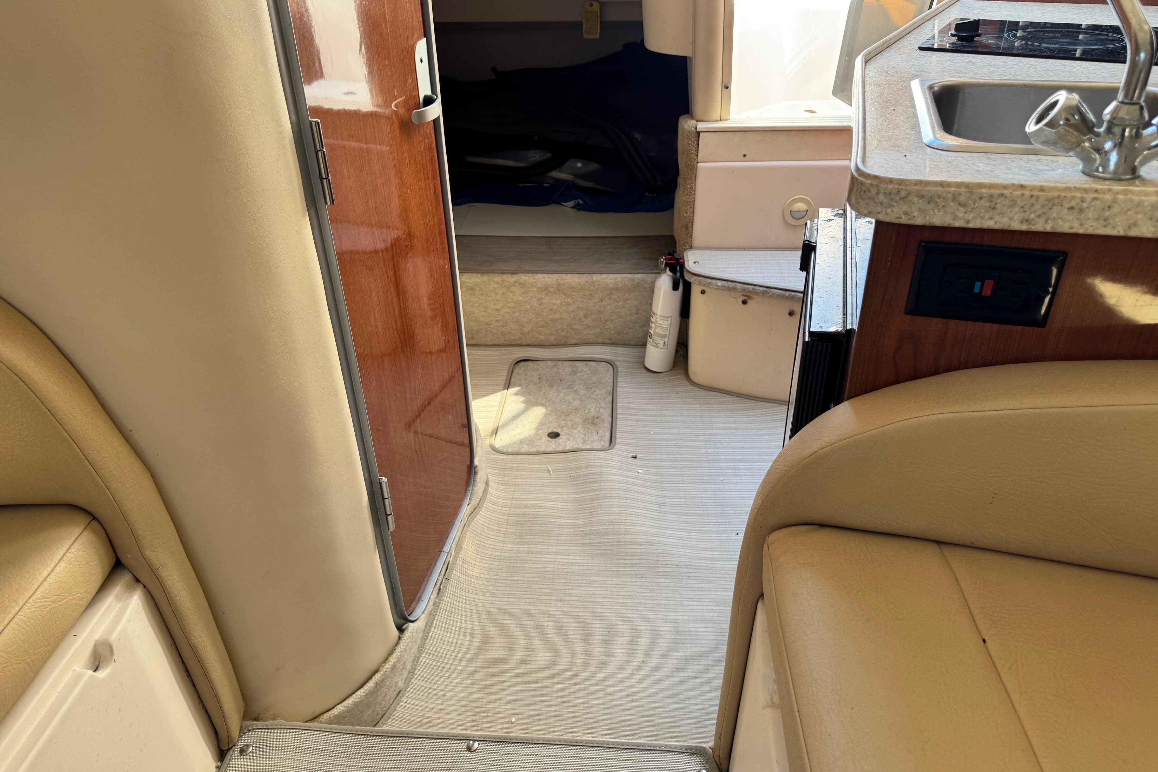 Interior of 2007 Regal Commodore 2665 boat, featuring cabin entrance and kitchenette area.