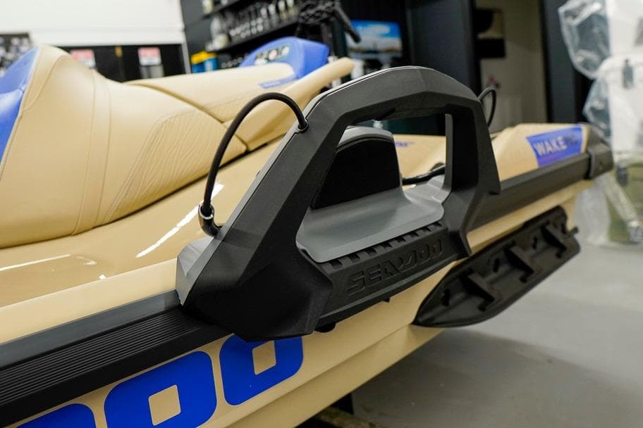 2026 Sea-Doo Wake Pro 230 jet ski with beige and blue seating in showroom.