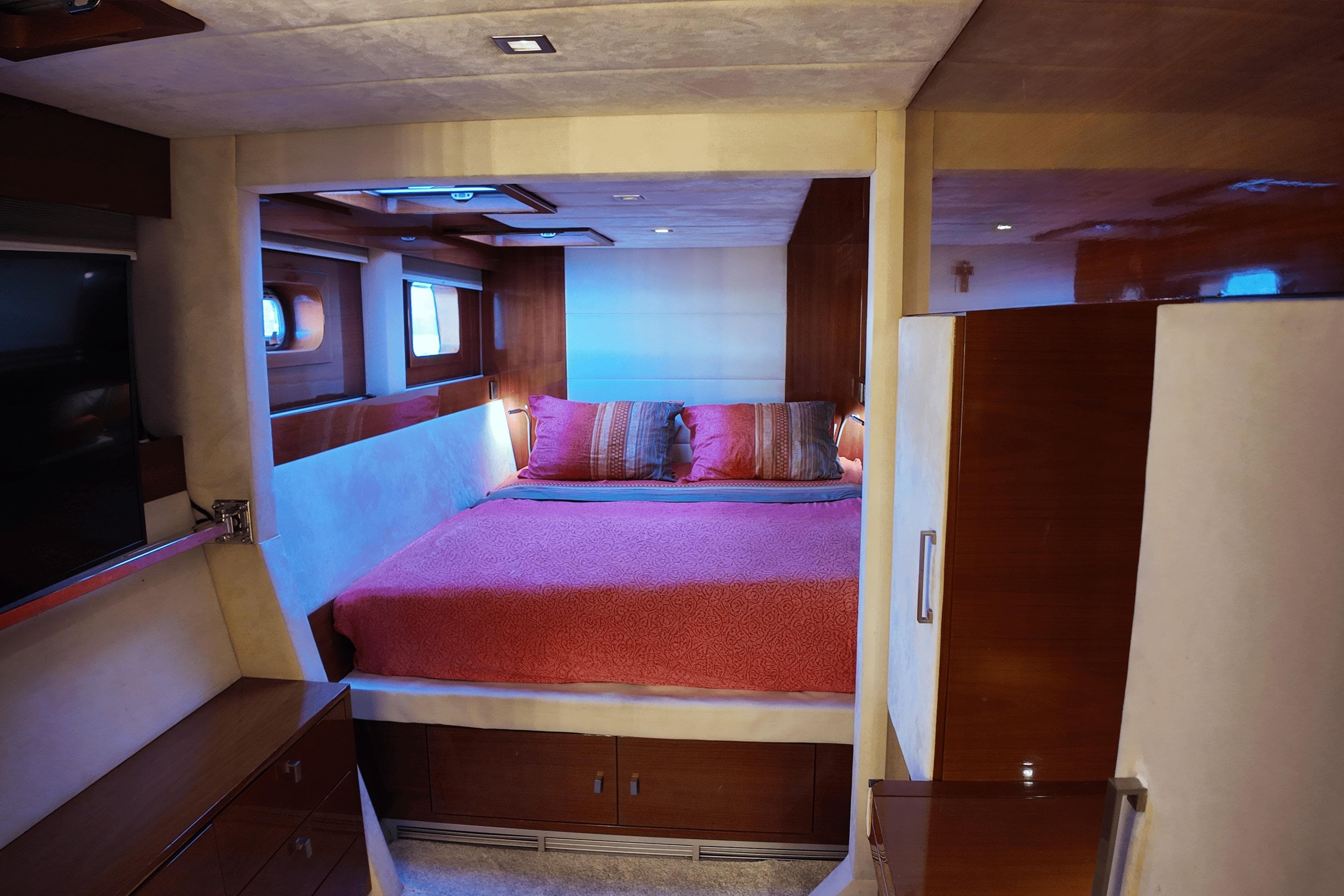 Luxurious Sunreef 62 yacht bedroom interior, 2011 model, featuring cozy bed and elegant wood finishes.