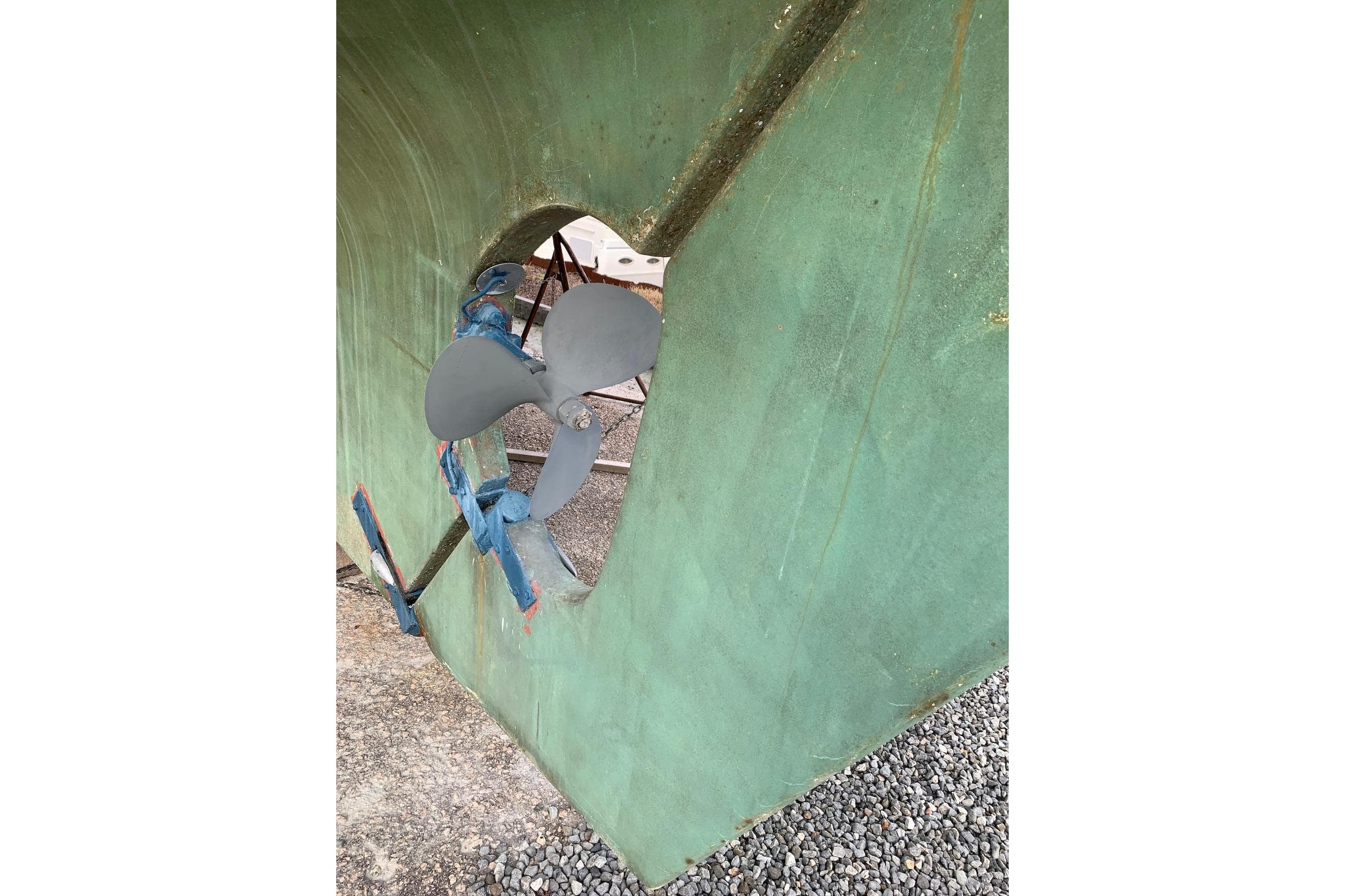 Propeller of 1981 Hardin 45 sailboat on dry dock, green hull visible.