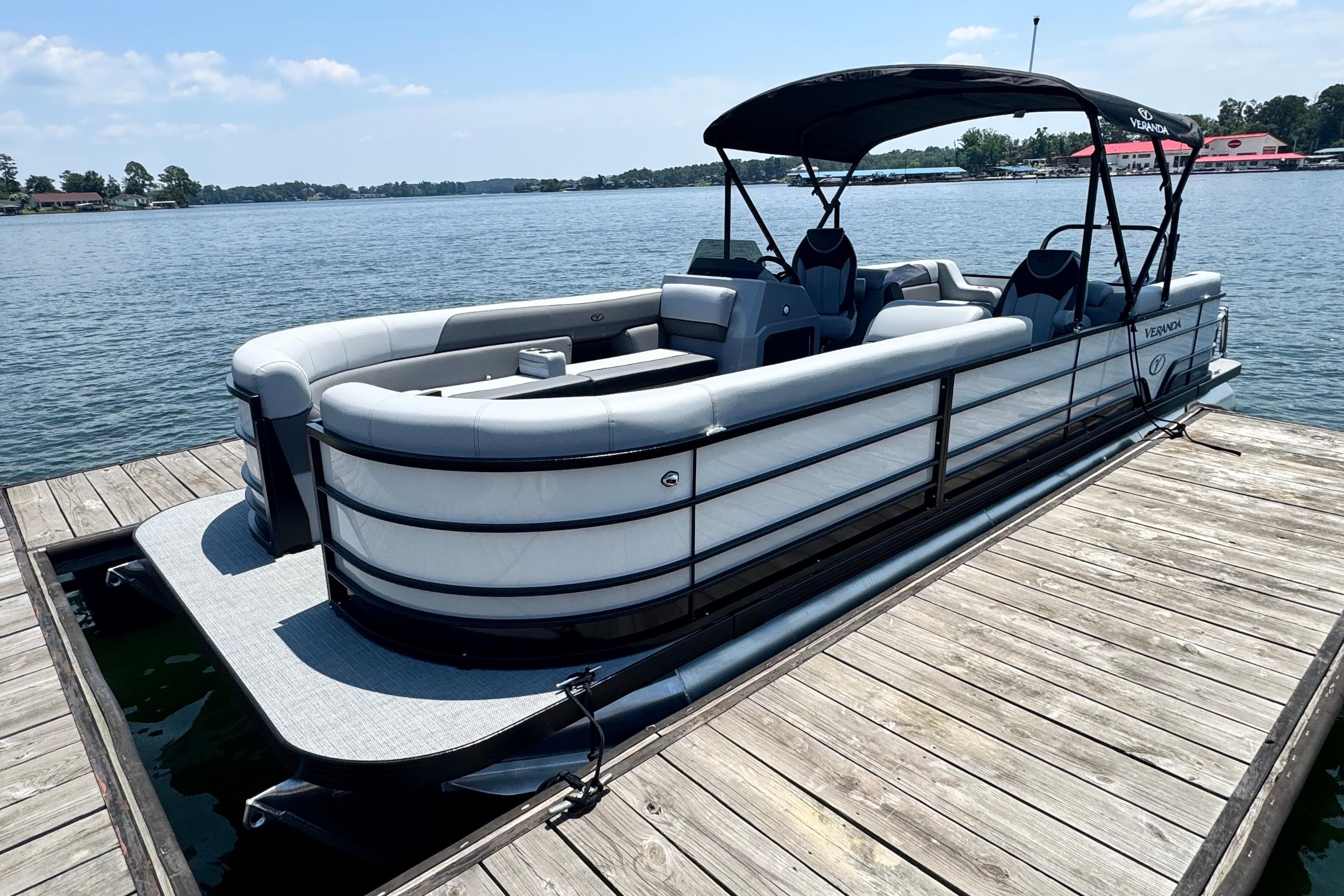 2026 Veranda Vista Sport VS25RC pontoon boat docked on a sunny lake.