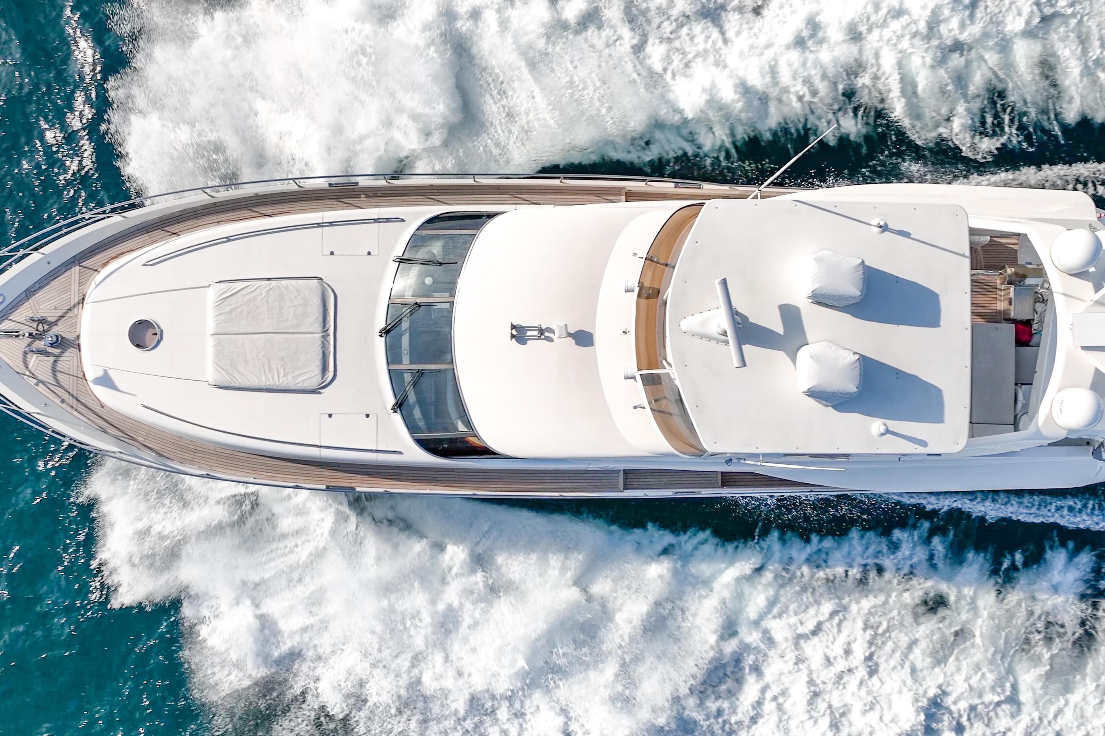 Aerial view of 2004 Viking Princess Flybridge yacht cruising on blue ocean waters.