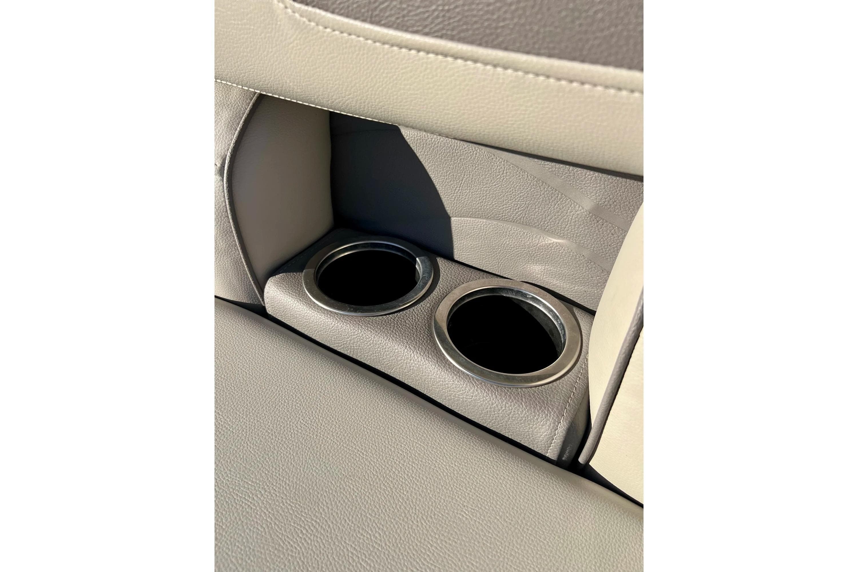 2021 SMOKERCRAFT EX20C boat interior with dual cup holders in beige upholstery.