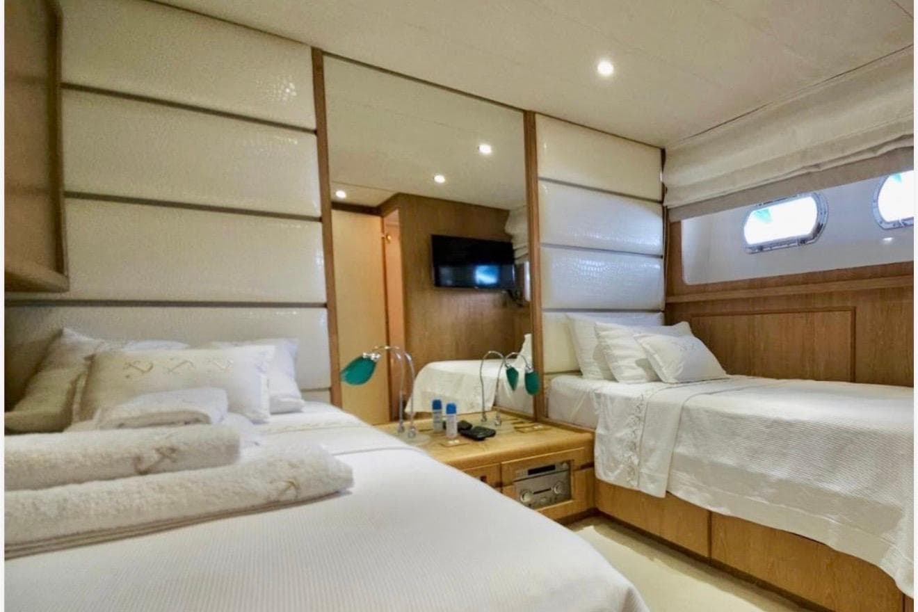 Luxurious cabin interior of 1992 Cantieri di Pisa Akhir 30S yacht with twin beds.