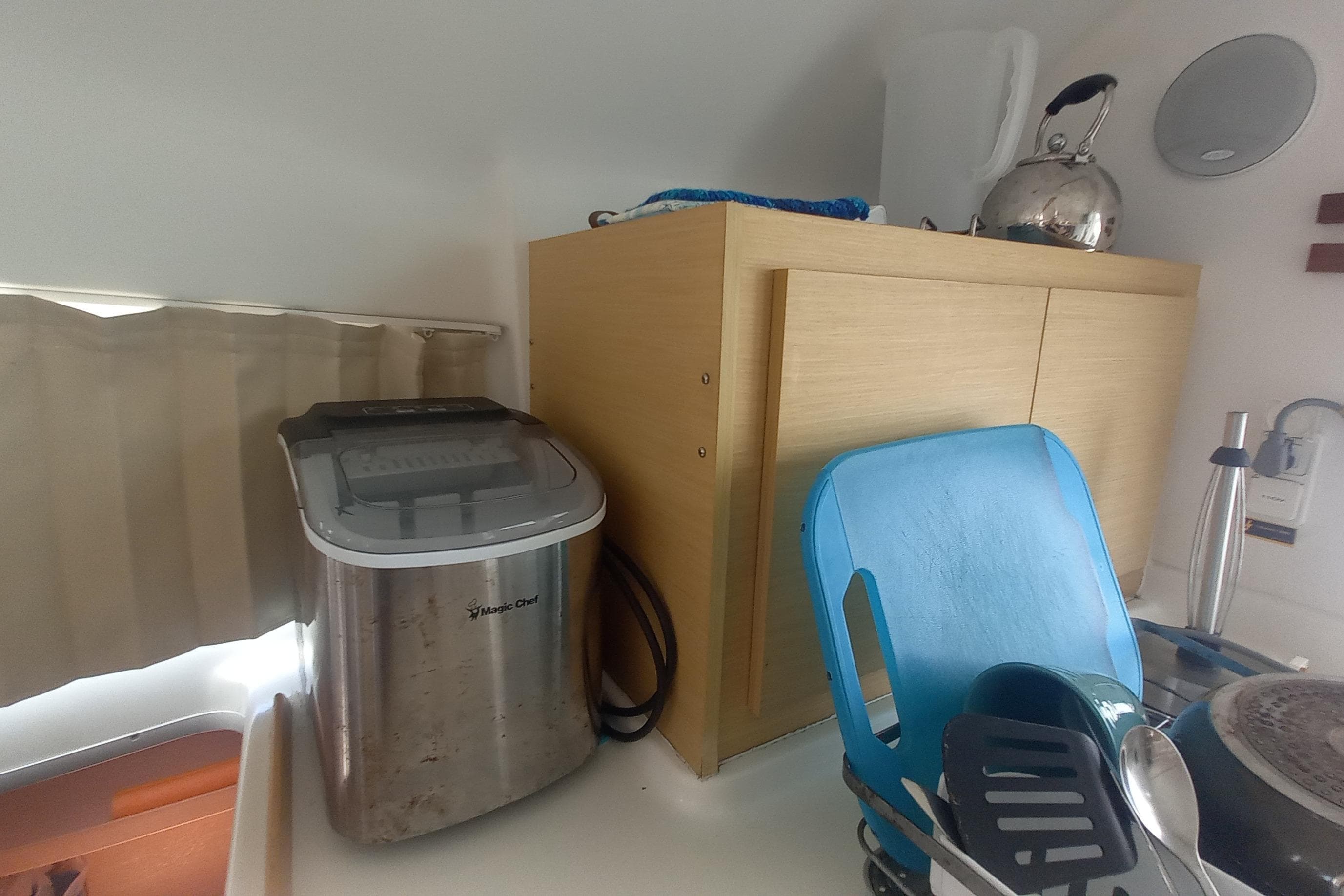 Kitchen area on a 2008 Lagoon 380 S2 yacht with appliances and utensils.